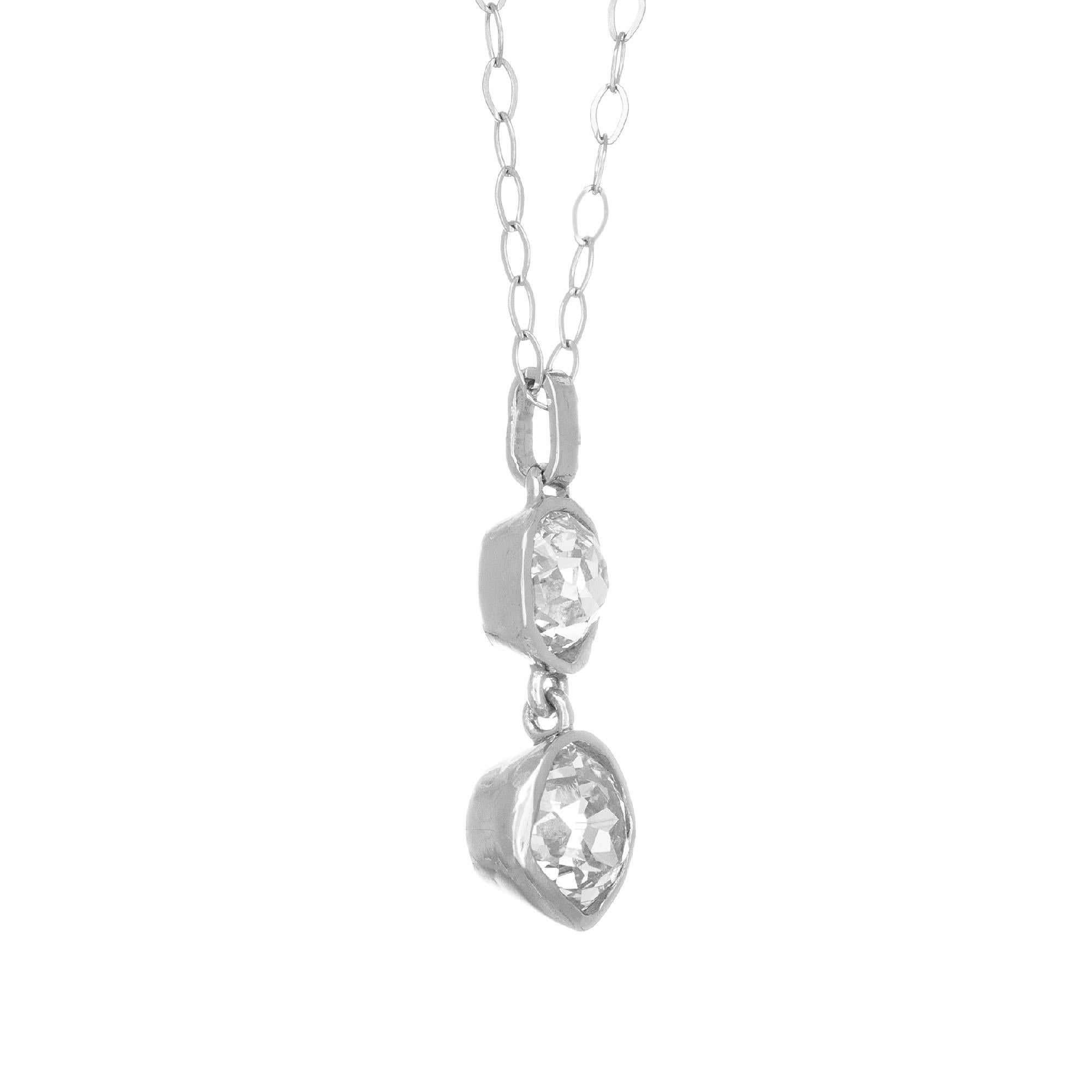 Odd shaped oval and cushion old mine cut diamond set into a classic dangle pendant in handmade 
platinum bezel from the Peter Suchy workshop.

1 old mine cut diamond I-J VS, approx. .37cts
1 old mine cut diamond L-M SI, approx. .63ct
Platinum