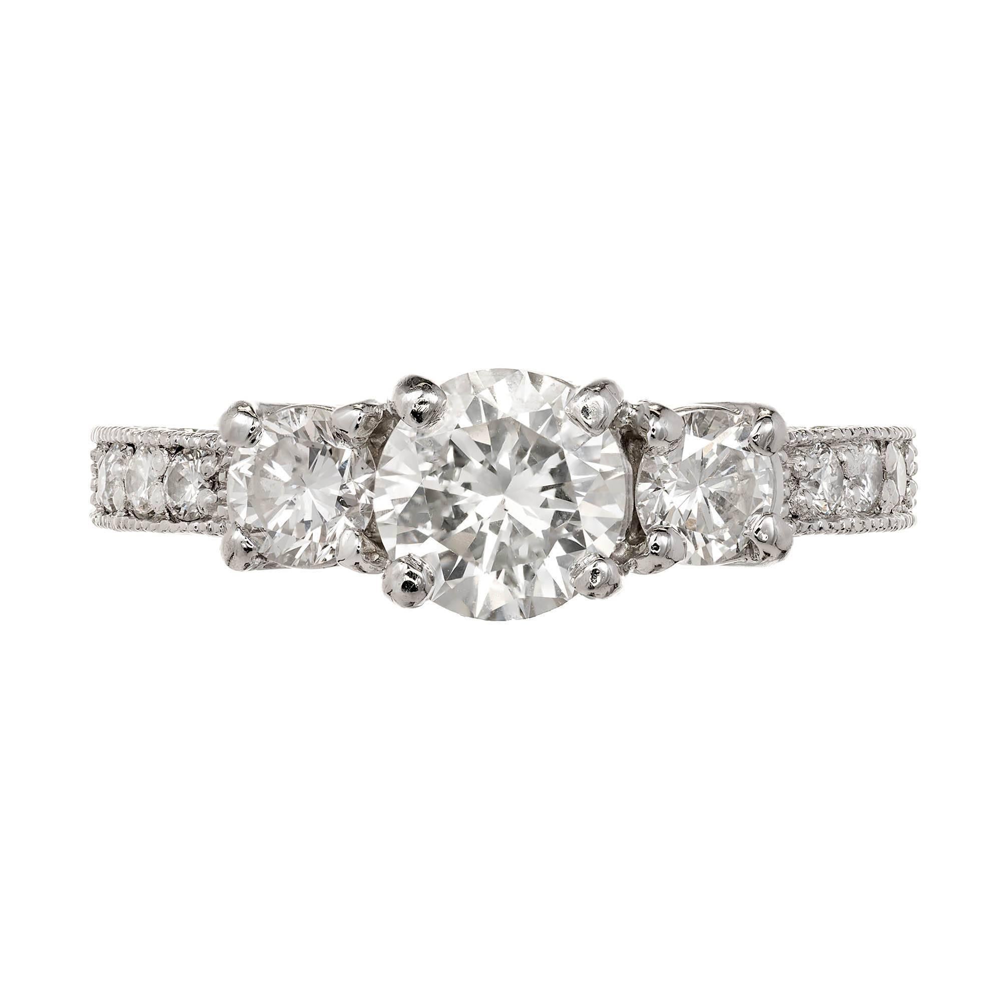 Peter Suchy vintage style custom made three-stone diamond platinum engagement ring.  GIA certified 1.00 carat sparkly center diamond flanked by two equally bright side diamonds in a curved prong top. The shoulders are mil-grained and set with full