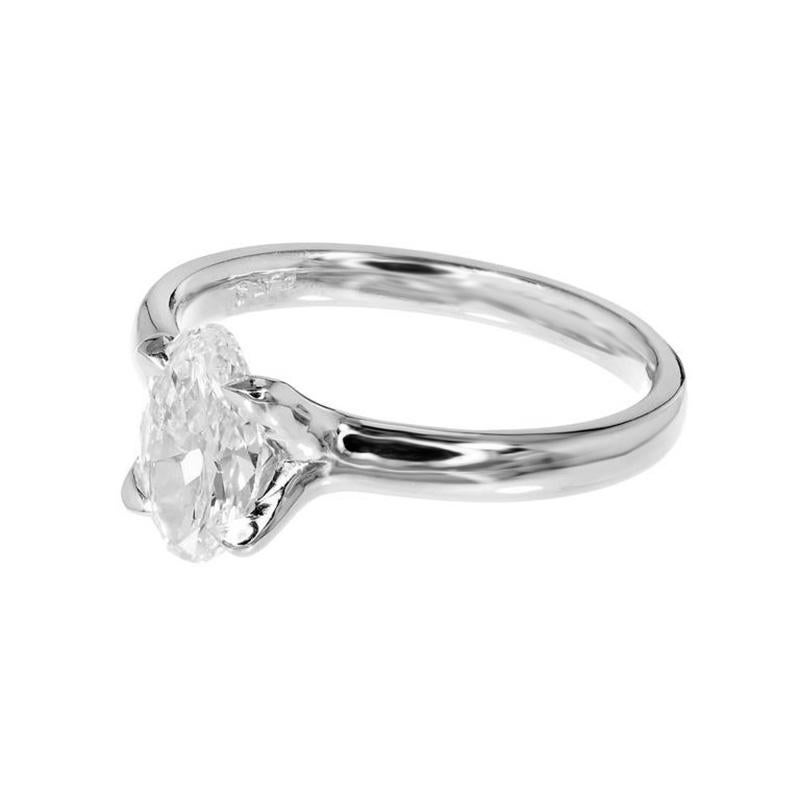 Diamond engagement ring. GIA certified elongated brilliant cut oval 1.00ct center diamond, mounted in a platinum setting. The crown is a simple “U” prong style to openly show off both sides of the diamonds and was created in the Peter Suchy