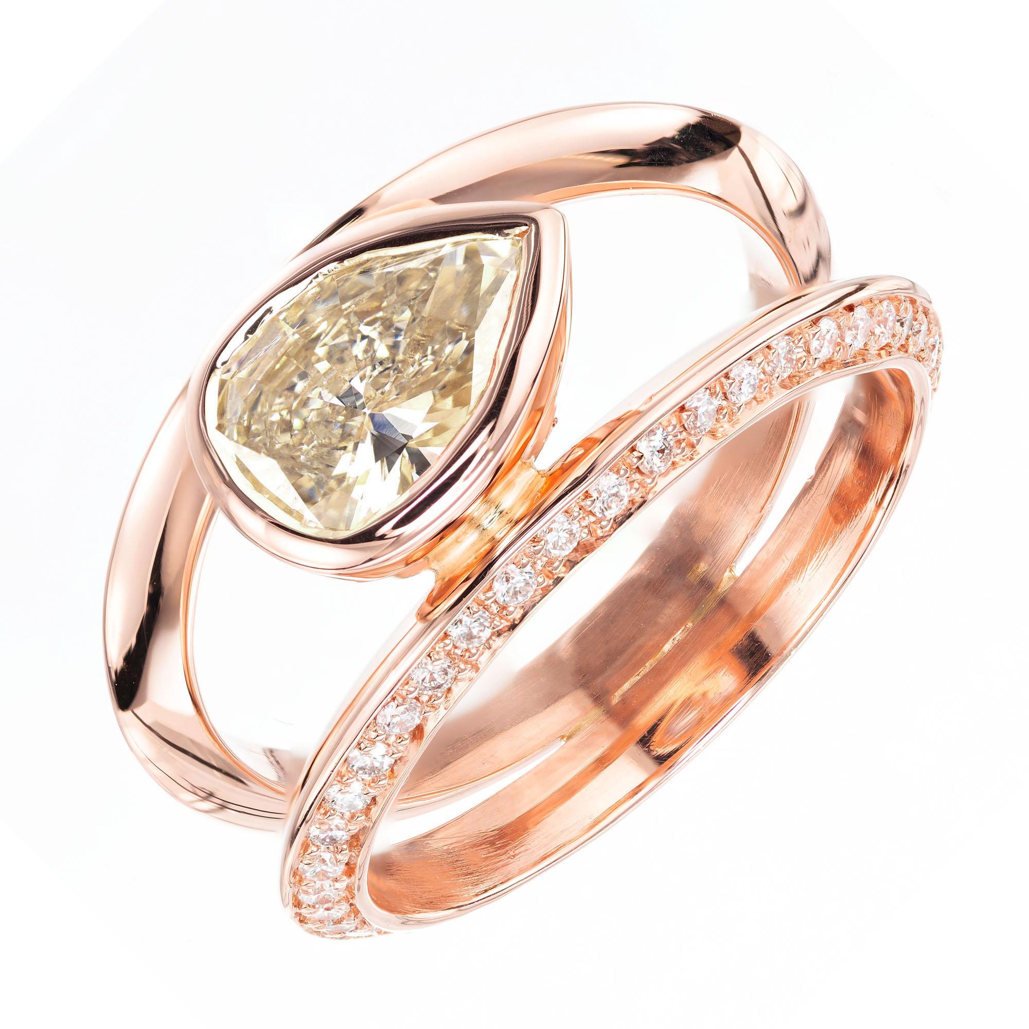 Pear shaped light brown diamond set sideways (East to West) modern alternative split shank engagement ring, with 72 pave set round full cut diamonds in a 14k rose gold setting, created in the Peter Suchy Workshop. 

1 pear shaped light brown