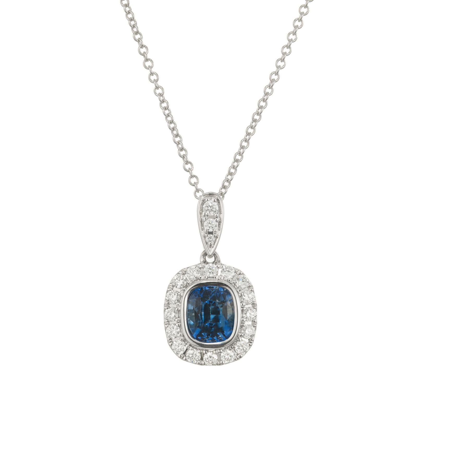 Sri Lankan periwinkle blue ICA certified cushion sapphire and diamond pendant necklace. At the center of this pendant is a cushion cut 1.05ct sapphire. Accented by a halo of full cut round diamonds. The 14k white gold chain is 18 inches in length.