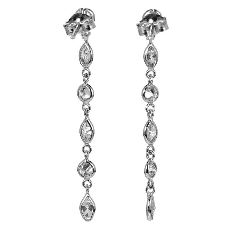 Elevate your elegance with the Peter Suchy 1.06ct. marquise and round diamond 14k white gold dangle drop earrings. These exquisite earrings are a masterpiece of sophistication, where each marquise cut bezel set diamond catches the light with