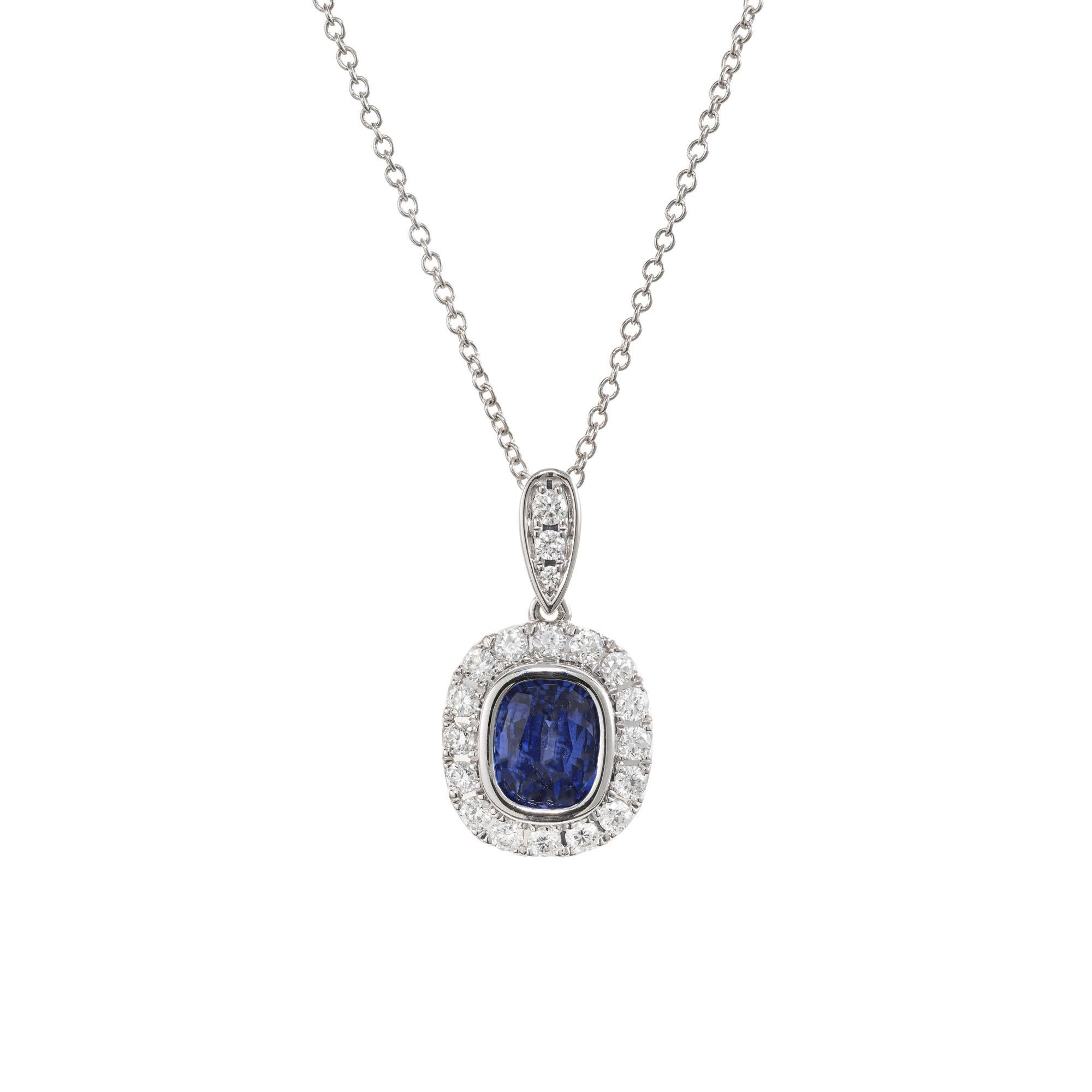 Peter Suchy blue sapphire diamond white gold pendant necklace. This beautiful piece showcases a 1.08 carat cushion cut brilliant blue sapphire, surrounded by dazzling halo of full cut diamonds, set in 14k white gold, accented by 3 diamonds on the