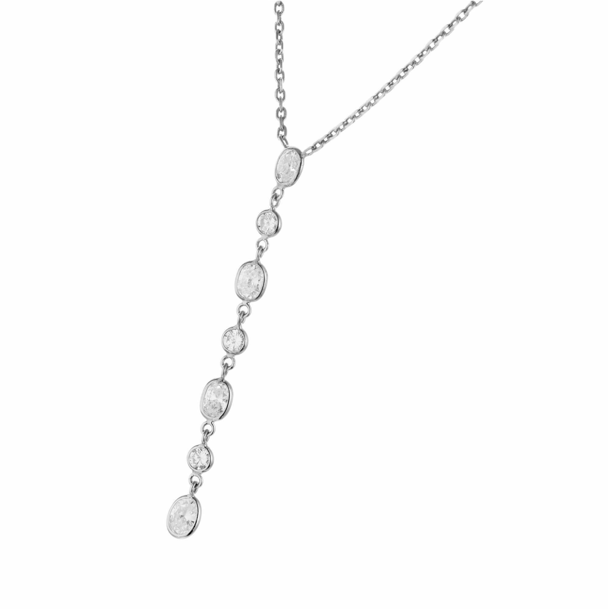 Diamond dangle drop necklace. 4 oval and 3 round bezel set diamonds in a 14k white gold drop cable chain. Designed and crafted in the Peter Suchy Workshop. 18 inch long chain. 

4 oval diamonds, approx. total weight .94cts
3 round diamonds, approx.