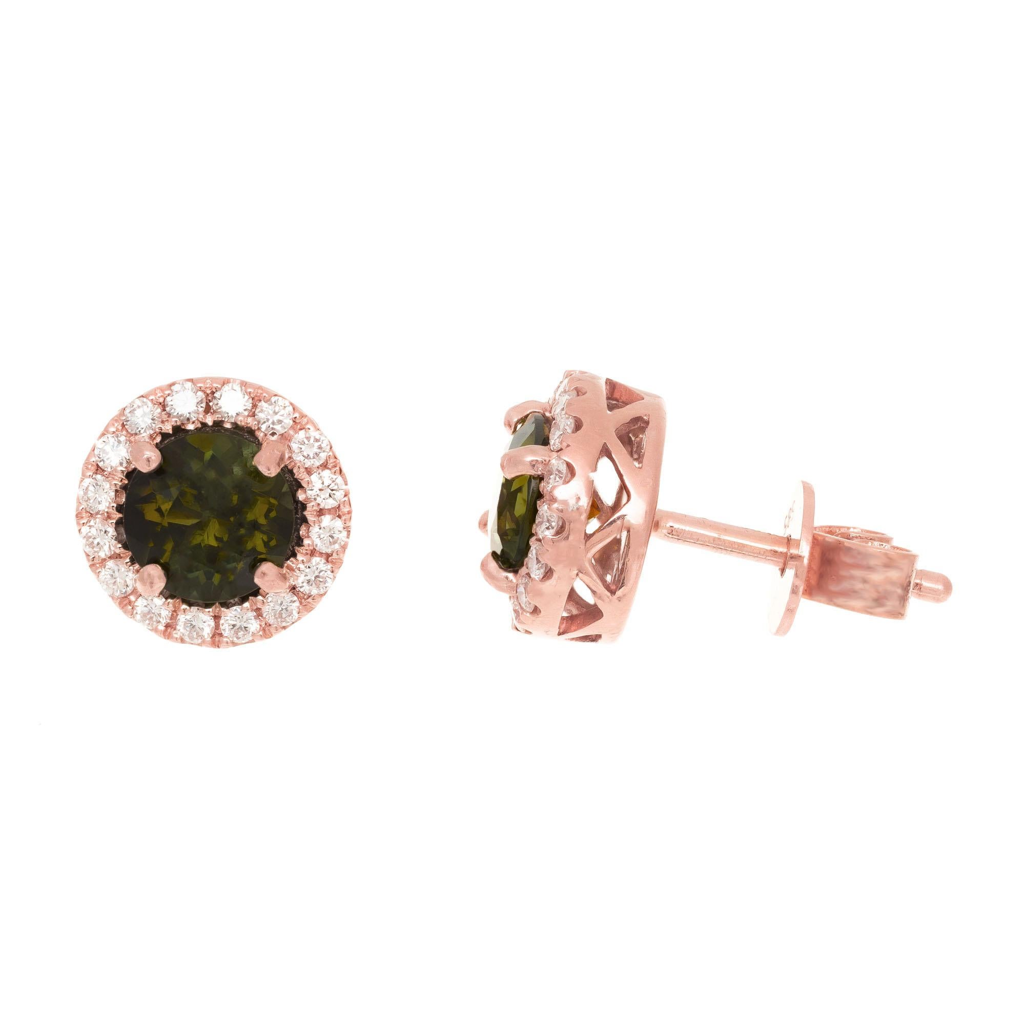 Peter Suchy tourmaline diamond stud earrings. 2 round green tourmalines with a halo of round brilliant cut diamonds set in 14k rose golds

2 round green tourmalines, 1.11cts
32 round brilliant cut diamonds, G-H VS approx. .25cts
14k rose gold