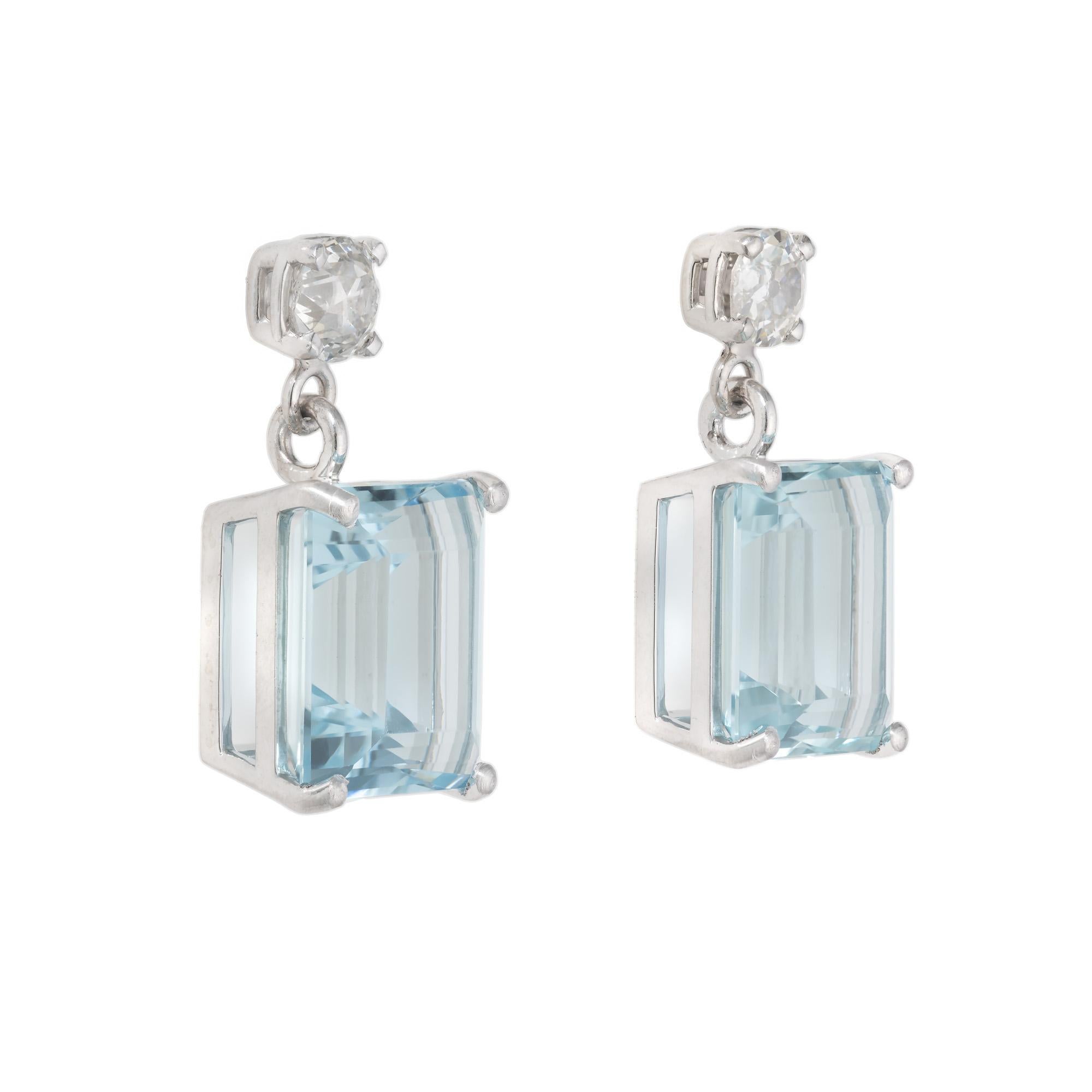 Platinum diamond aqua dangle earrings. Two natural untreated emerald cut aquamarines totaling 11.32cts set in  4 prong platinum settings. Each aqua is accented by one old mine cut diamond with both dating back to the 1900's. The aquas have a rich