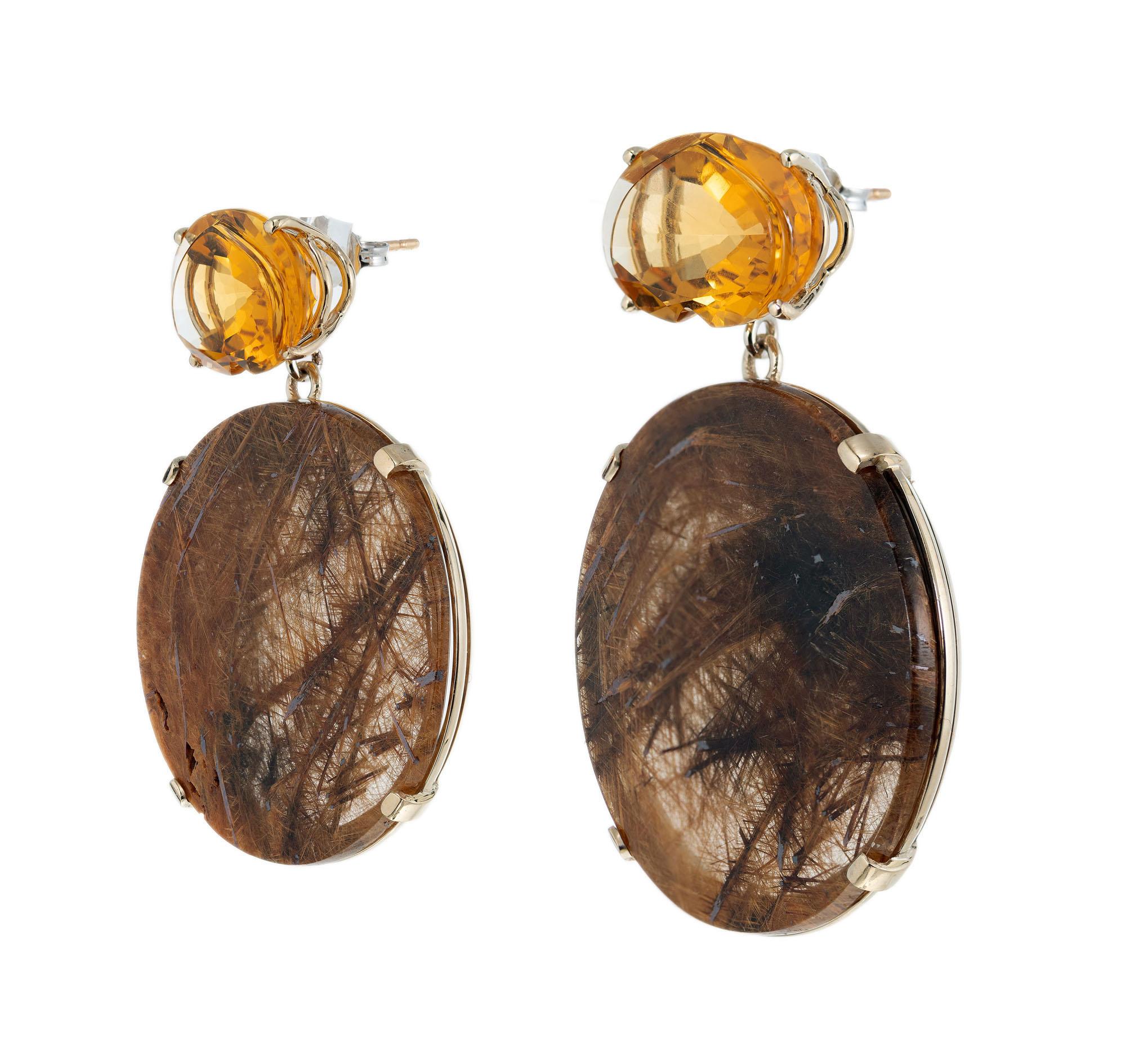 Natural Quartz and citrine large dangle earrings. Set in 14k yellow gold, created in the Peter Suchy Workshop.

2 golden yellow fancy cut natural Citrine, approx. total weight 17.50cts, VS, 16.6 x 11mm
2 round golden yellow rutilated Quartz, natural