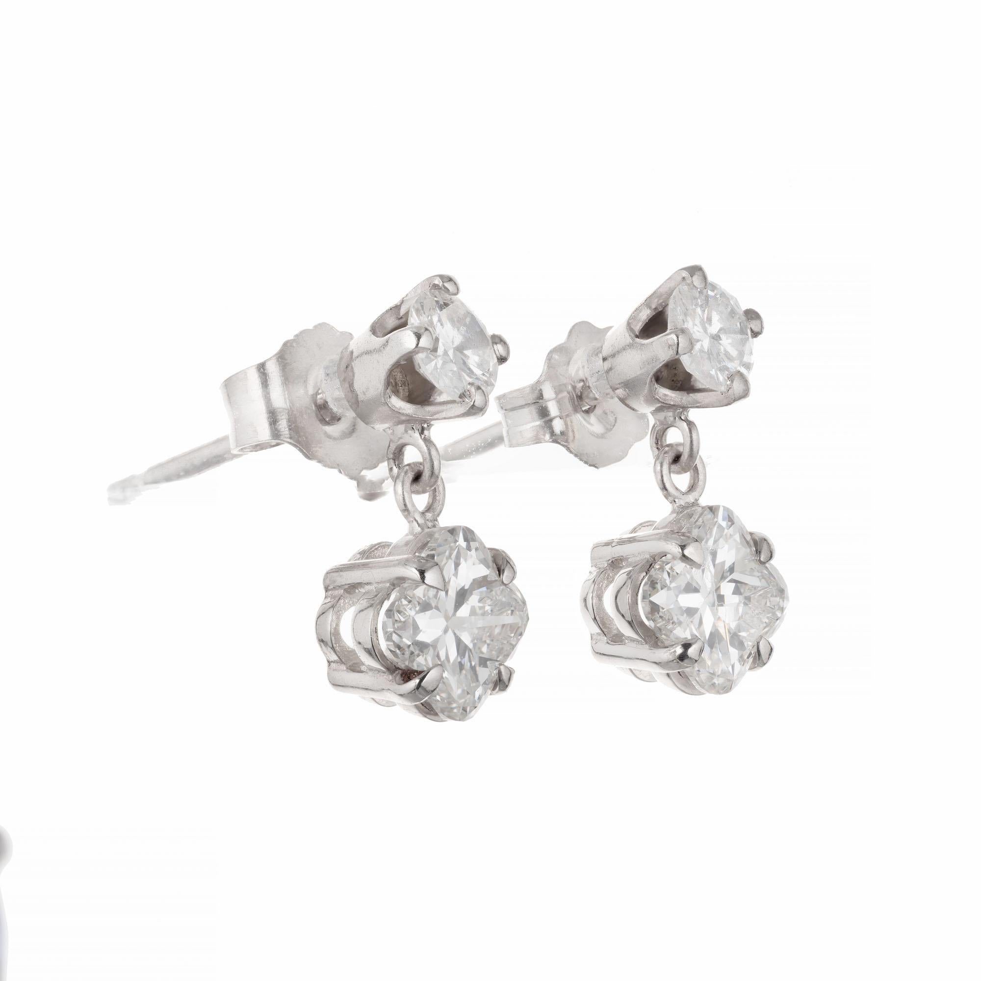 Lily cut diamond dangle earrings. 2 lily cut diamonds with 2 round accent diamonds set in platinum. Made in the Peter Suchy Worshop

2 lily cut diamonds GH VS, approx. .98cts
2 round brilliant cut diamonds GHVS-SI approx.  .27cts
Platinum 
Stamped: