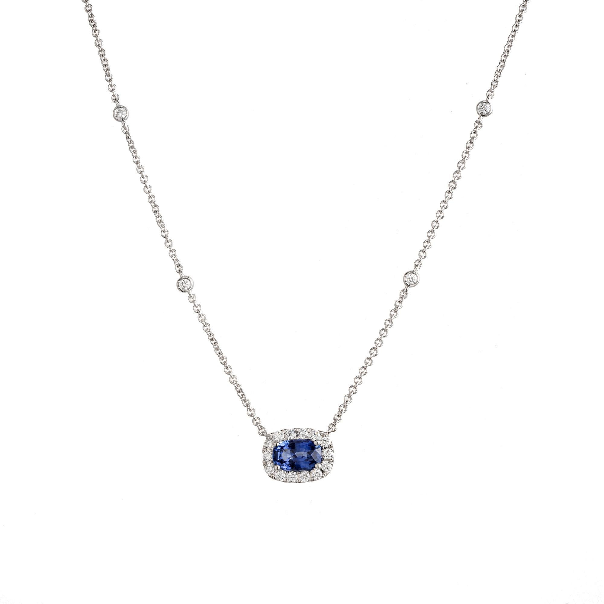 Cushion set sapphire and diamond pendant necklace. 1.29ct oval sapphire which is set sideways and is adorned with a halo of 24 round brilliant cut diamonds. The sapphire is certified by the ICA GemLab as natural, no heat with an origin of Sri Lanka.