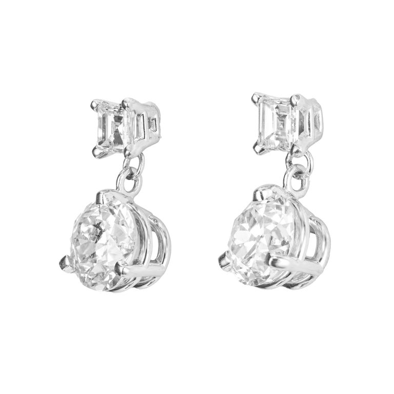Dangle diamond earrings. Two Old European round diamonds totaling 1.29cts set in 14k white gold 3 prong settings each accented with a square step cut diamond. The stones are circa 1920's that were fashioned into classic dangle earrings that were