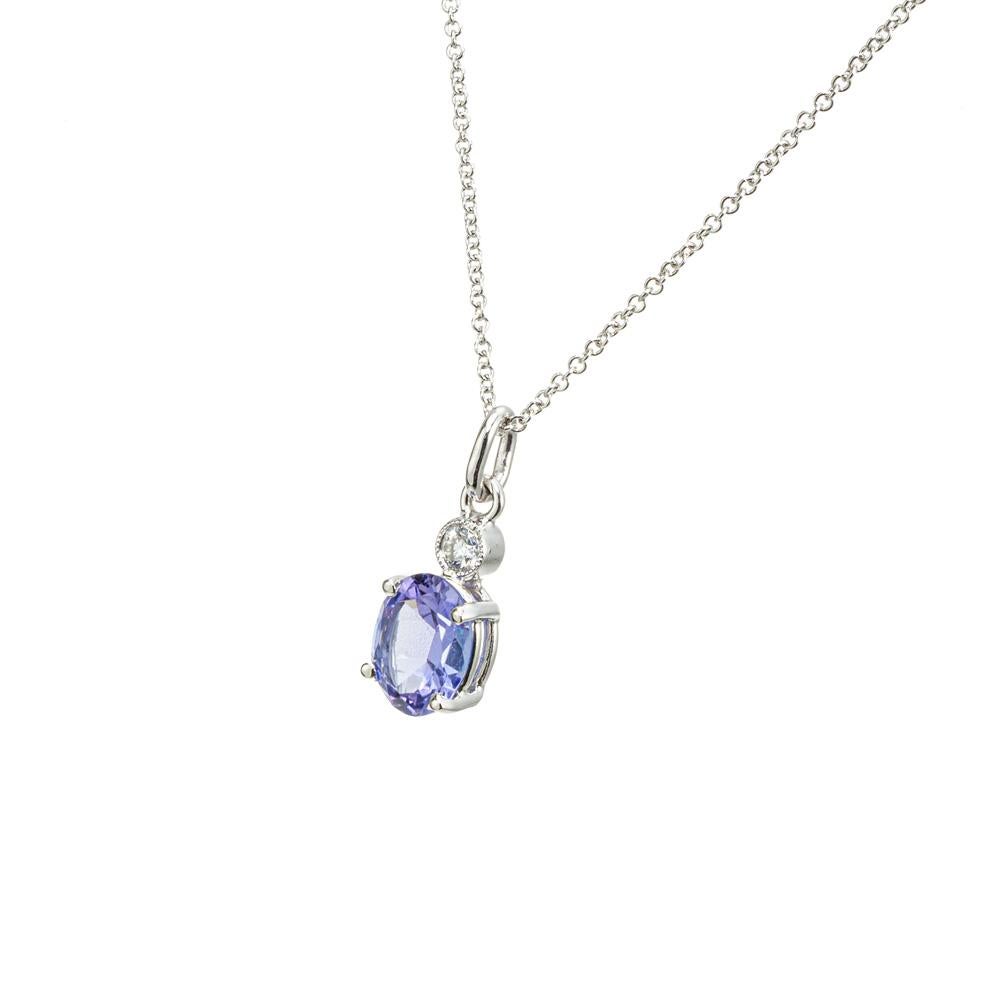 Tanzanite and diamond pendant necklace. AGL certified oval 1.29cts Tanzanite gemstone in a simple four prong 14k white gold setting with an accent diamond above. 15.5 inch chain. Crafted in the Peter Suchy Workshop.

1 oval blue tanzanite, approx.