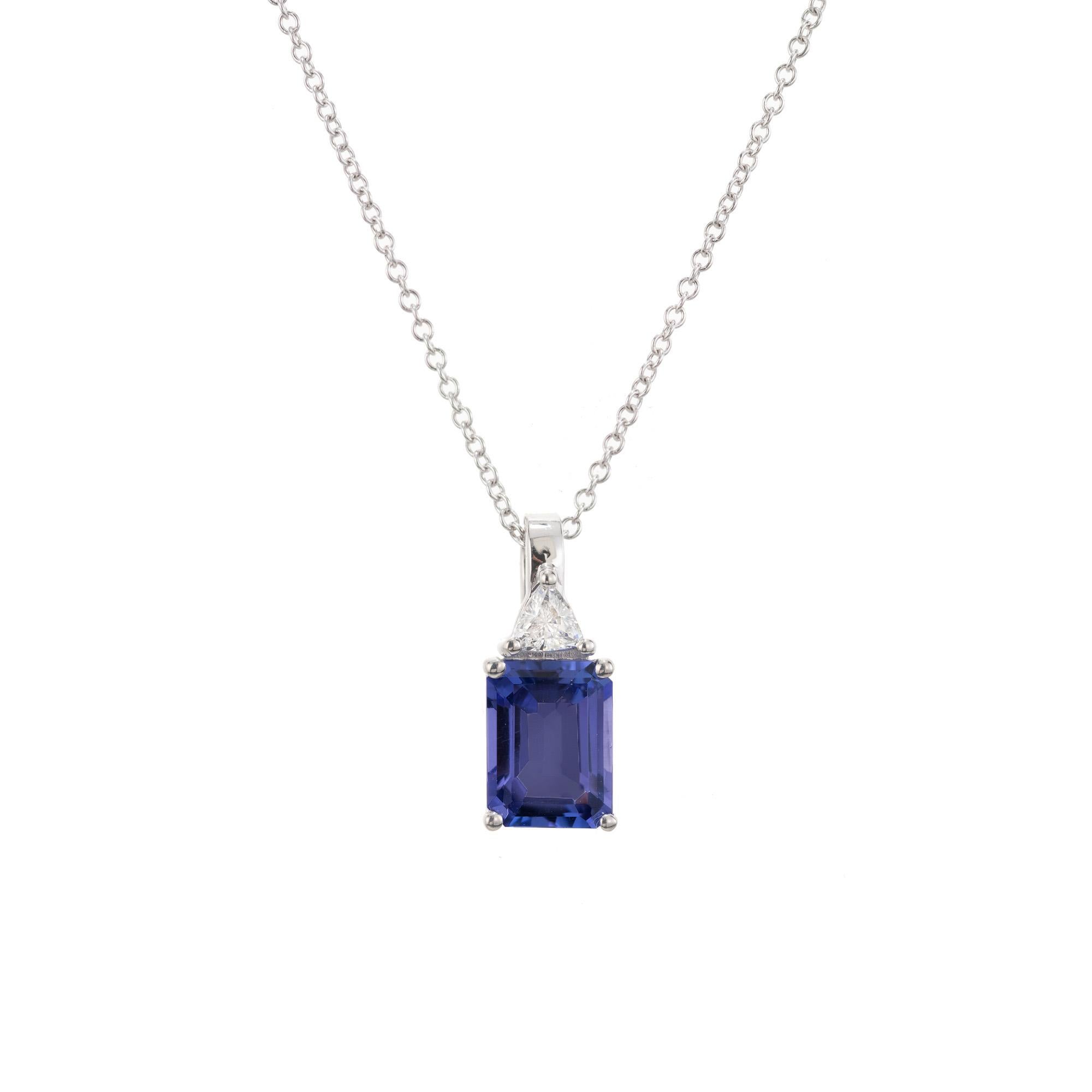 Beautiful tanzanite and diamond pendant necklace. 1.30ct emerald cut tanzanite mounted in a 14k white gold four prong setting accented with 1 trilliant shape diamond. 14k white gold 18 inch chain. Designed and crafted in the Peter Suchy Workshop

1