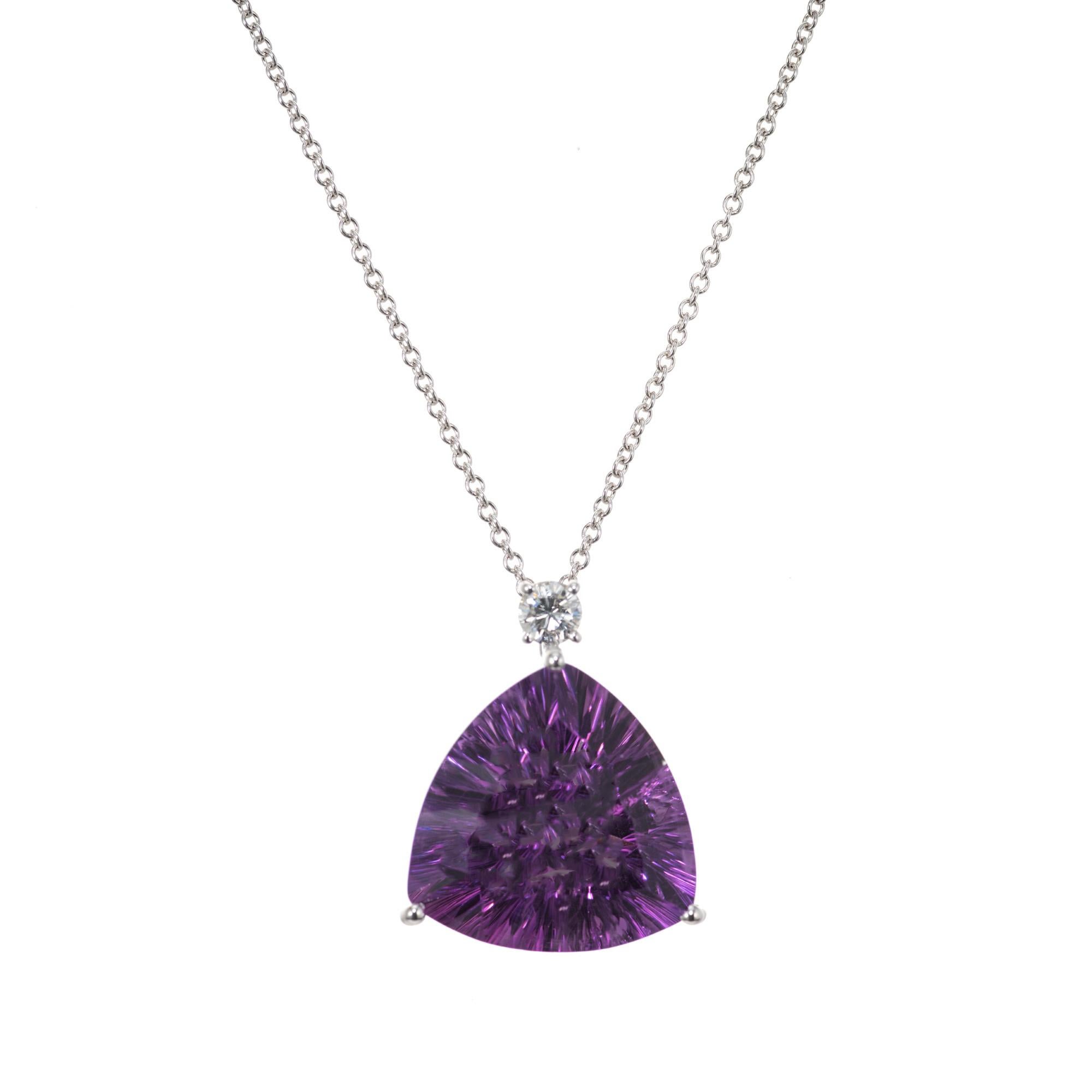 Rich purple amethyst and diamond pendant necklace. This spectacular fantasy cut triangular 13.04 carat amethyst is set in a simple three prong hand made 14k white gold setting, accented with one round brilliant cut diamond. 16 inch 14k white gold
