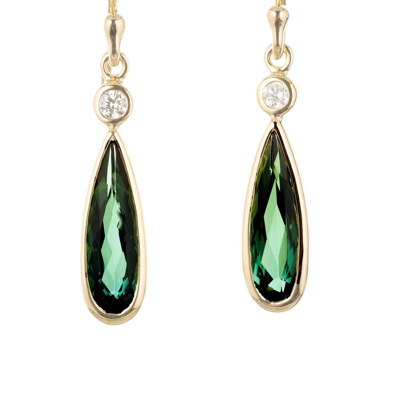 Green pear shaped tourmaline and round diamond dangle earrings. Handmade bezel in 18k  yellow gold. Made in the Peter Suchy Workshop

2 pear shape bluish green tourmaline, approx.  1.40cts
2 round brilliant cut diamonds G-H VS, approx.  .8ct
18k