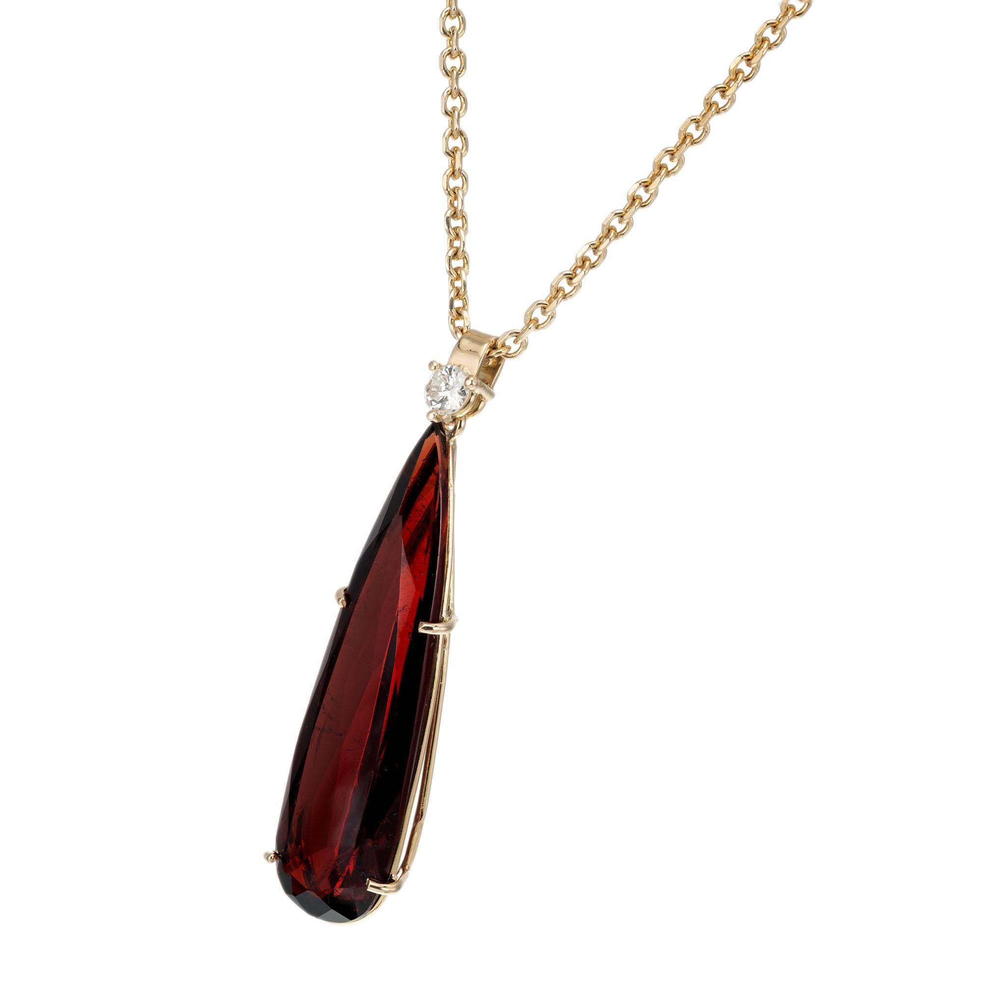 Brownish red pear shape garnet pendant with a round diamond accent in 14k yellow gold from the Peter Suchy Workshop. 16 Inch 14k yellow gold chain

1 pear shape brownish red garnet, approx. 14.93ct
1 round brilliant cut diamond G SI, approx.