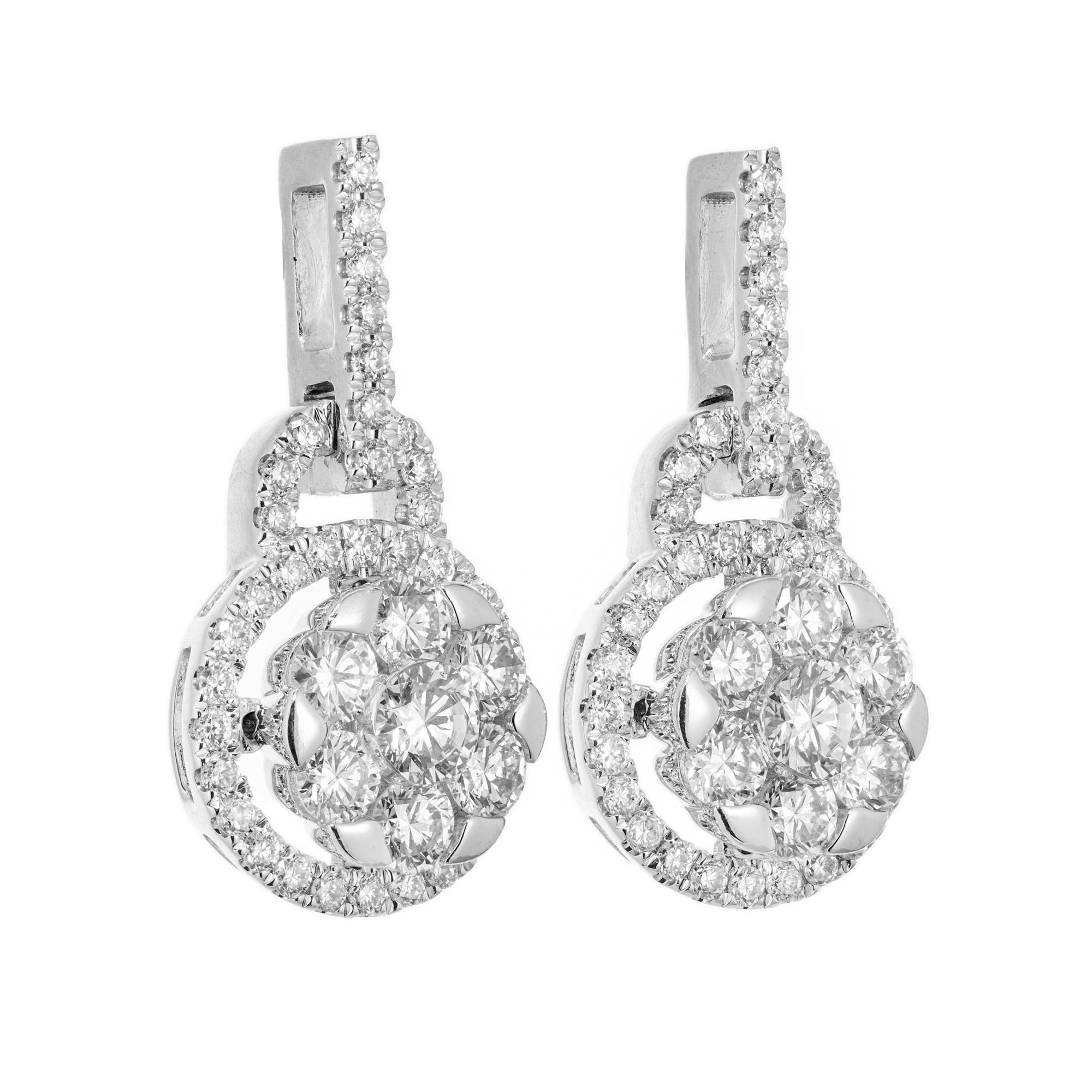 Suspended diamond circular target earrings. 88 round brilliant cut diamonds totaling 1.50cts make up these 14k white gold radiant dangle earrings. Each dangle has a cluster of 7 round diamonds in the middle with a halo of diamonds that are attached