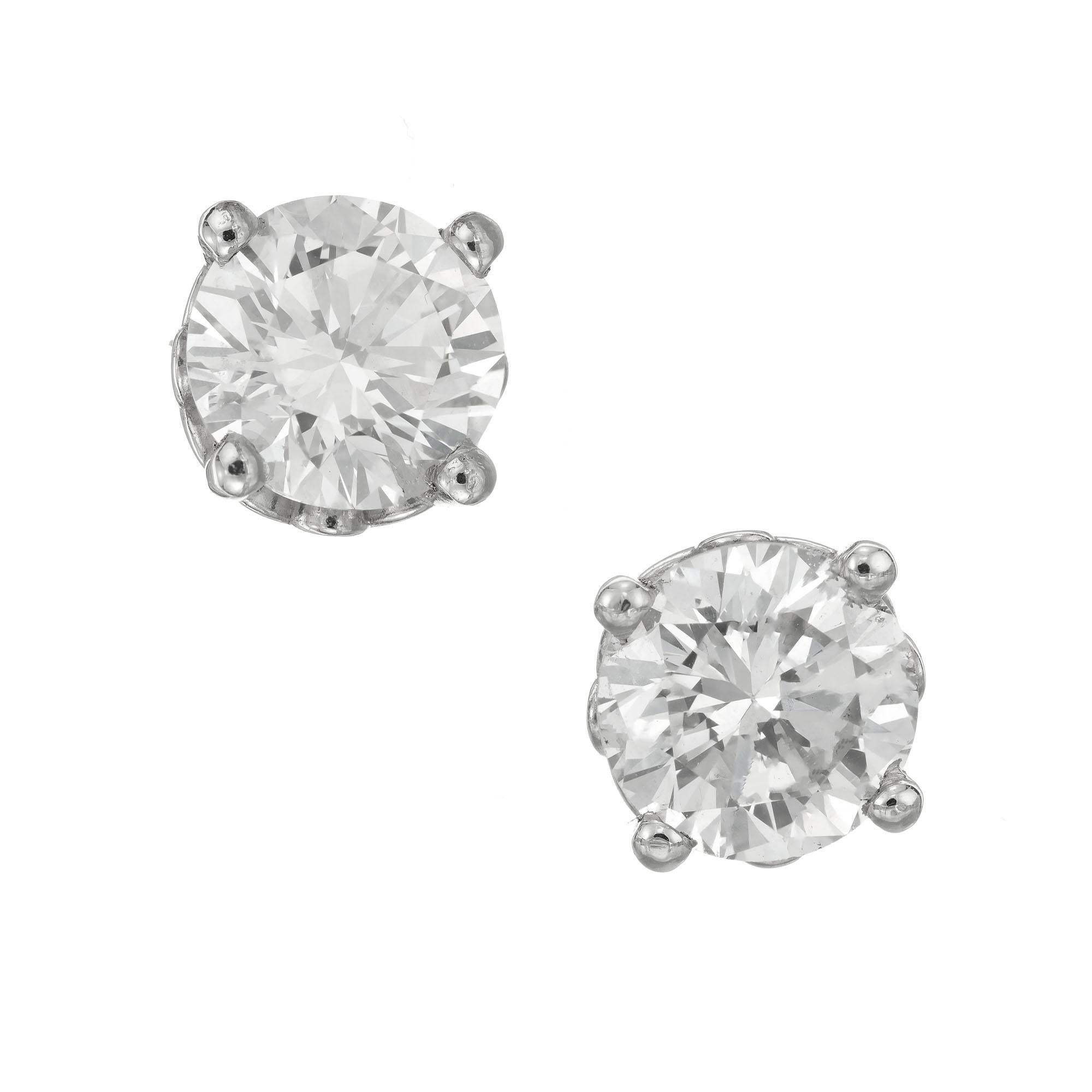 Round diamond stud earrings. 2 GIA certified round brilliant cut diamonds in platinum, 4 prong scroll basket settings. Created in the Peter Suchy Workshop. 

1 round brilliant cut diamond. Approx. total weight: .75cts L, I1  5.91x5.87x3.5mm. GIA