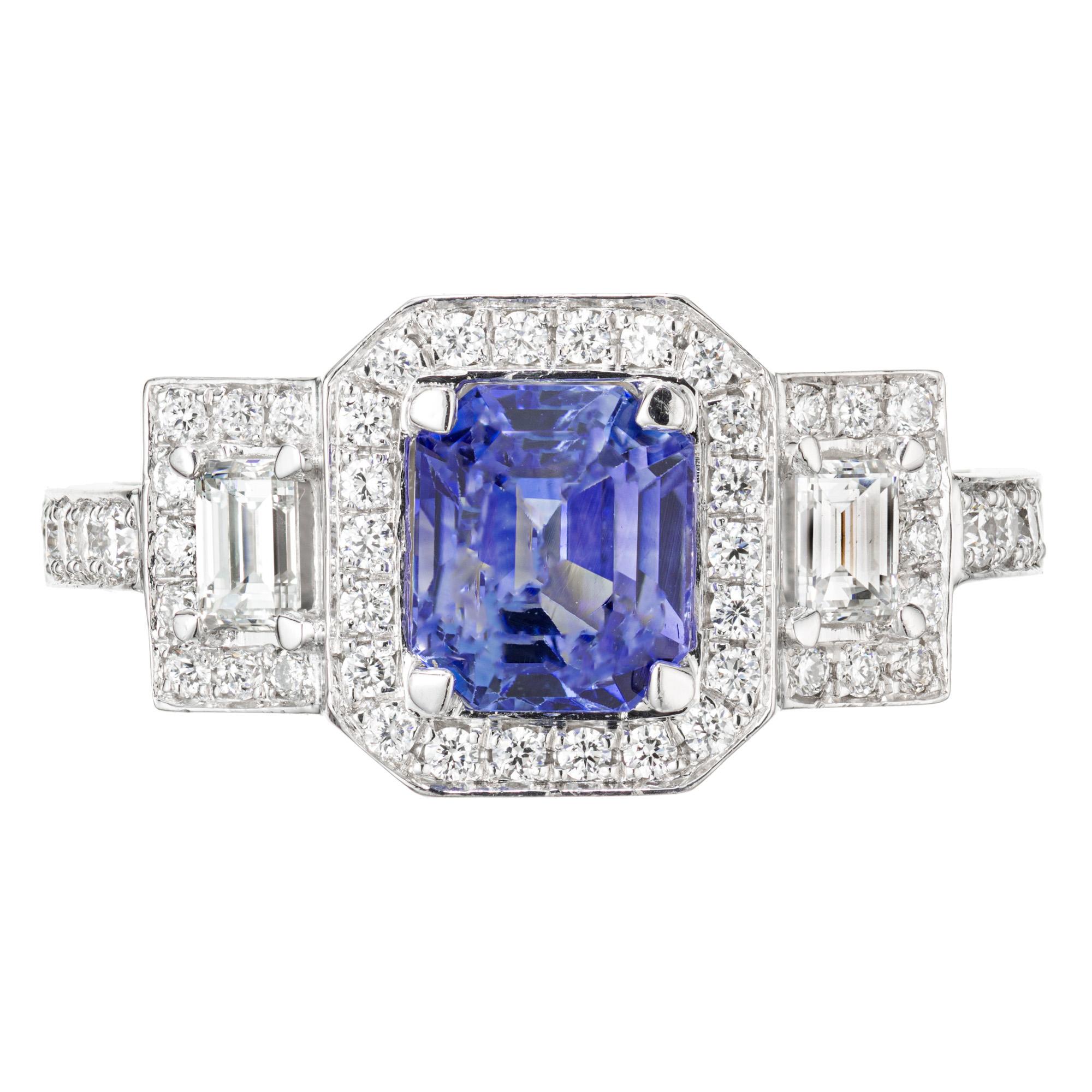 Sapphire and diamond three-stone engagement ring. AGL certified emerald cut sapphire center stone, set in a platinum triple diamond halo setting with 2 baguette side diamonds. Sapphire is certified as natural corundum, simple heat only. Designed and