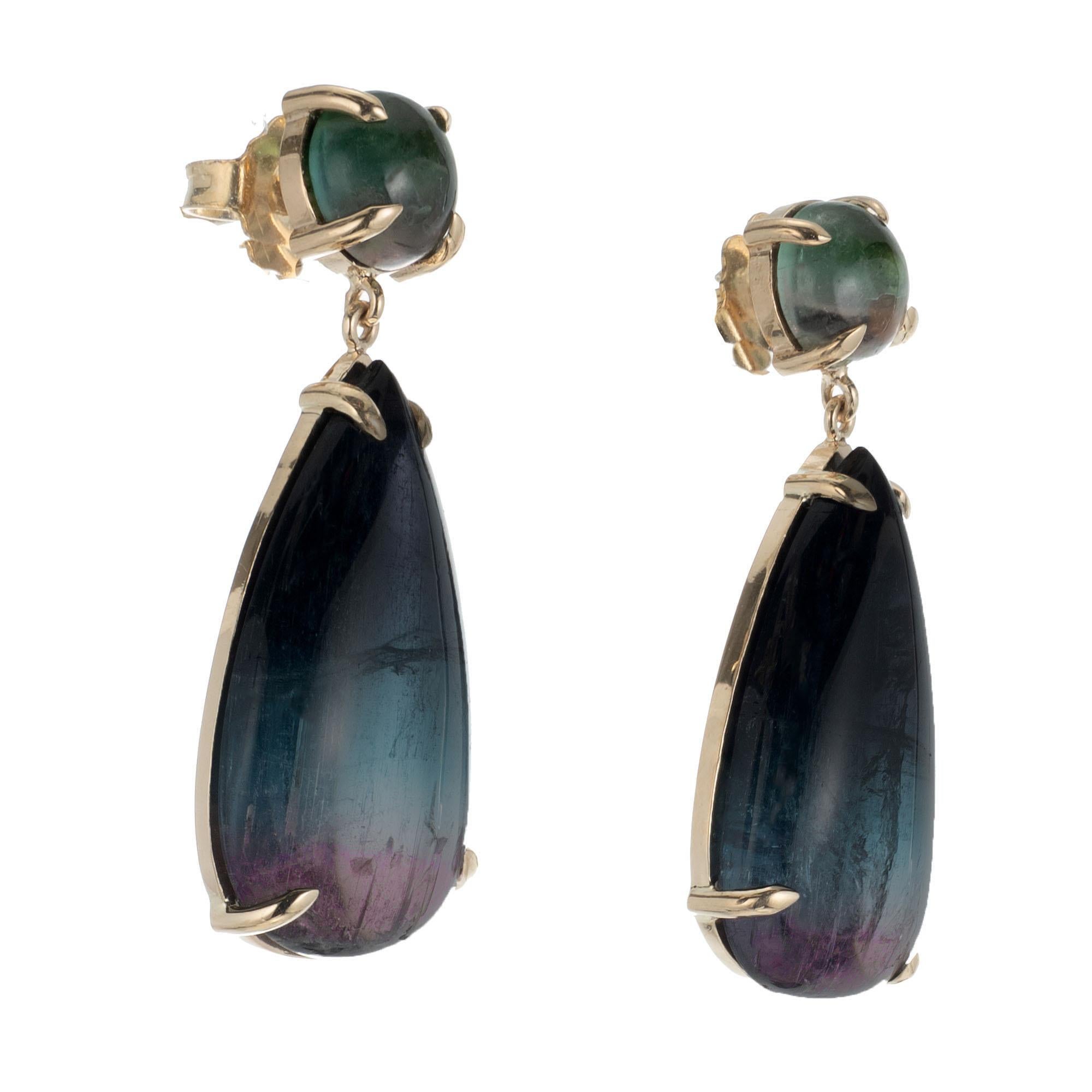 Peter Suchy natural untreated blue and pink tourmaline dangle earrings. Set in 14k yellow gold. Blue tourmaline's that fade into pink hues at the bottom of the stones. Designed and made in the Peter Suchy workshop

2 blue, white and pink cabochon