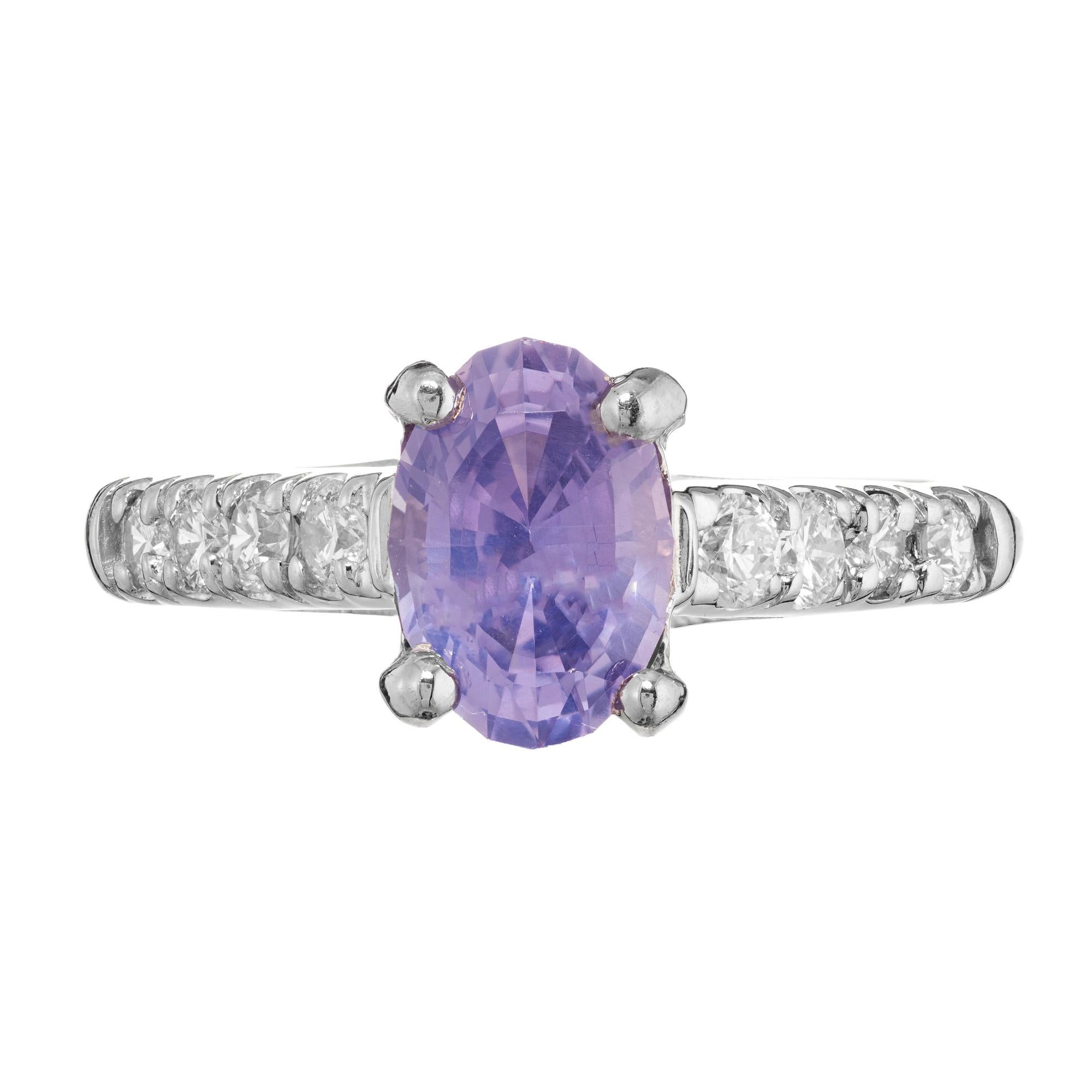 Violet sapphire and diamond platinum engagement ring is a masterpiece of elegance. This exquisite ring features a mesmerizing blue violet 1.60cts sapphire center stone mounted in a platinum setting. Both shoulders of the shank are adorned with 4