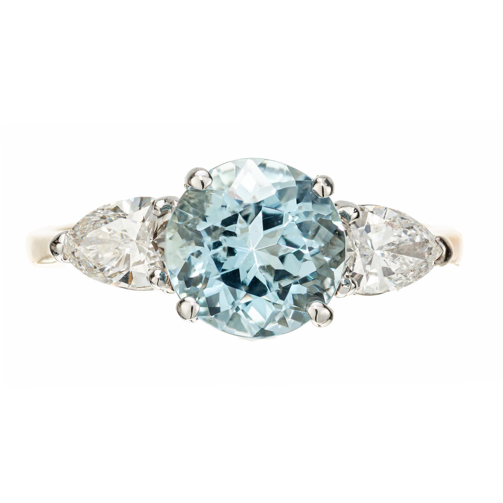 Aquamarine and diamond engagement ring. 1.65 round aqua center stone set in a 14k white and yellow gold setting with two pear shaped side diamonds. Designed and crafted in the Peter Suchy Workshop.

1 round blue aquamarine, VS approx. 1.65cts
2 pear