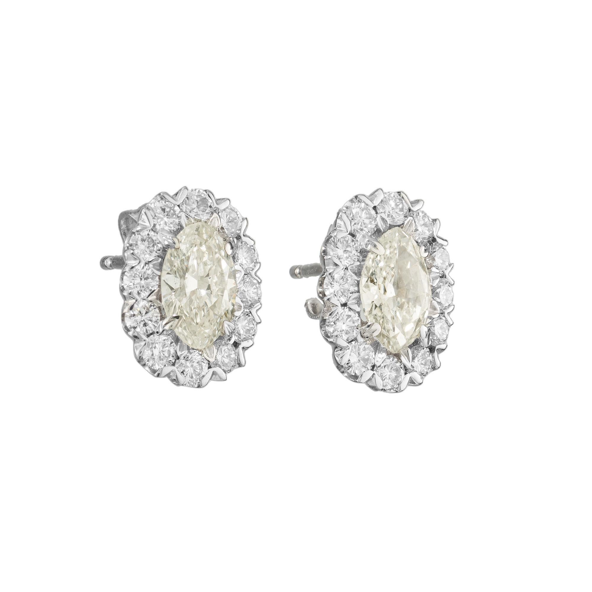 Dazzling antique style 1.65 carat marquise and round diamond halo earrings in 14k white gold. The halo is filled with top quality full cut diamonds held in place by small V sections surrounding the center marquise stones. This gives the earrings a