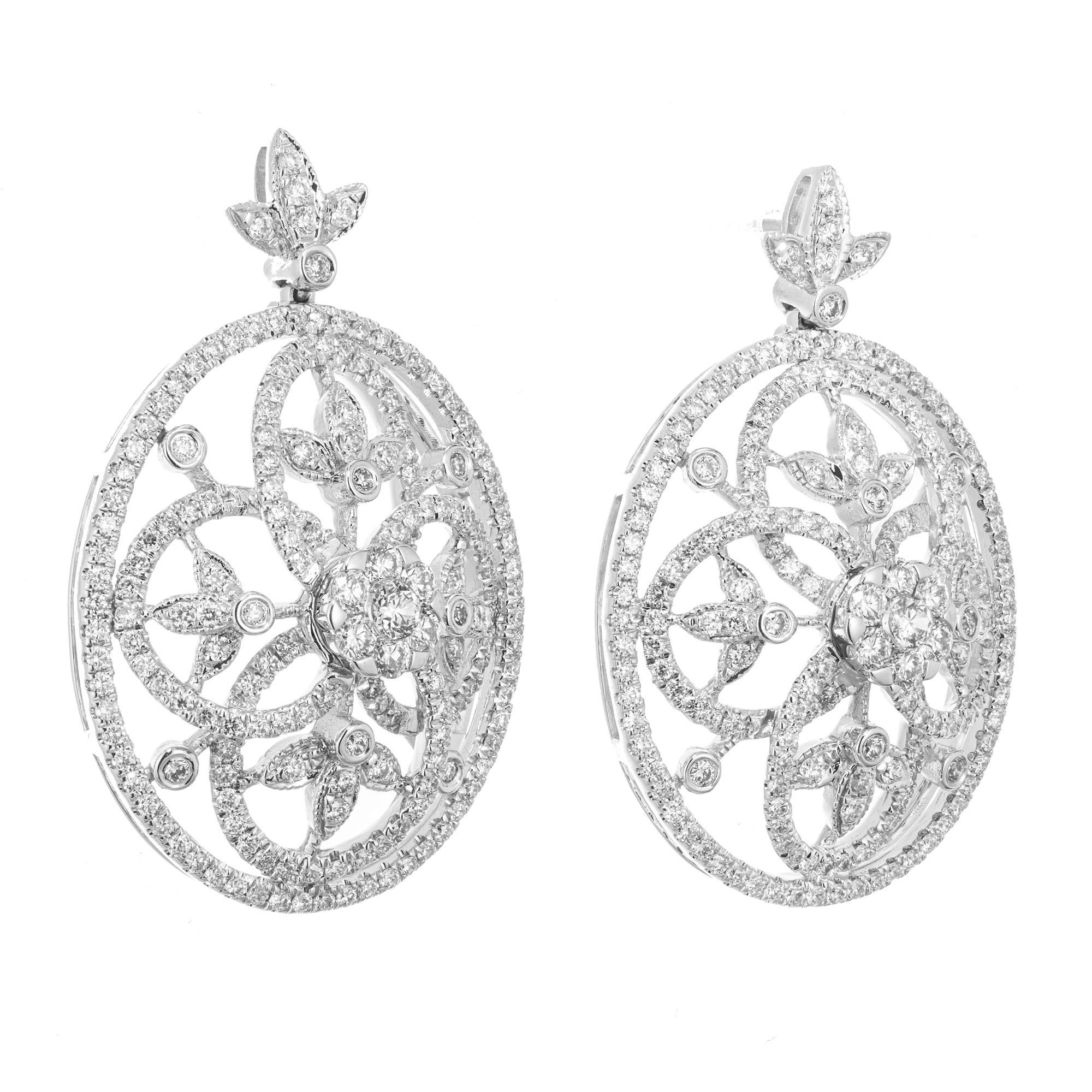 Spectacular open swirl diamond dangle earrings. Oval shaped 14k white gold raised dome framed settings with 374 round brilliant cut diamonds totaling 1.75cts. Each dangle has detailed inside swirls of diamonds making these earrings truly
