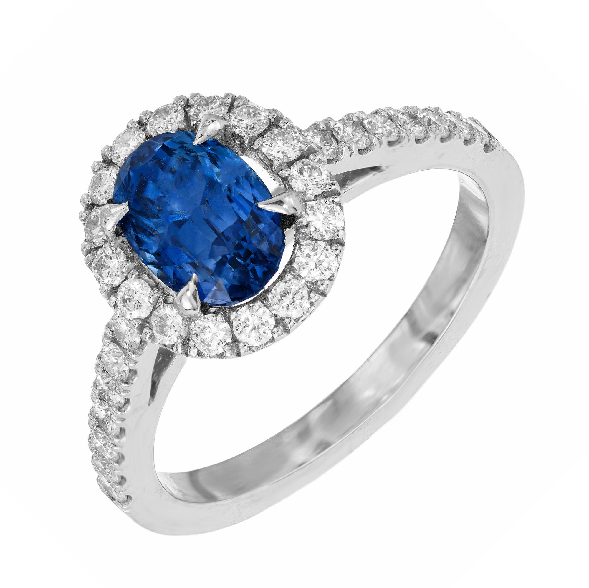 Peter Suchy sapphire and diamond engagement ring. The center piece of this ring is a 1.77ct oval sapphire mounted in 18k white gold with a a halo of round cut diamonds. Accented with diamonds along both sides of the shank. AGL has certified it a