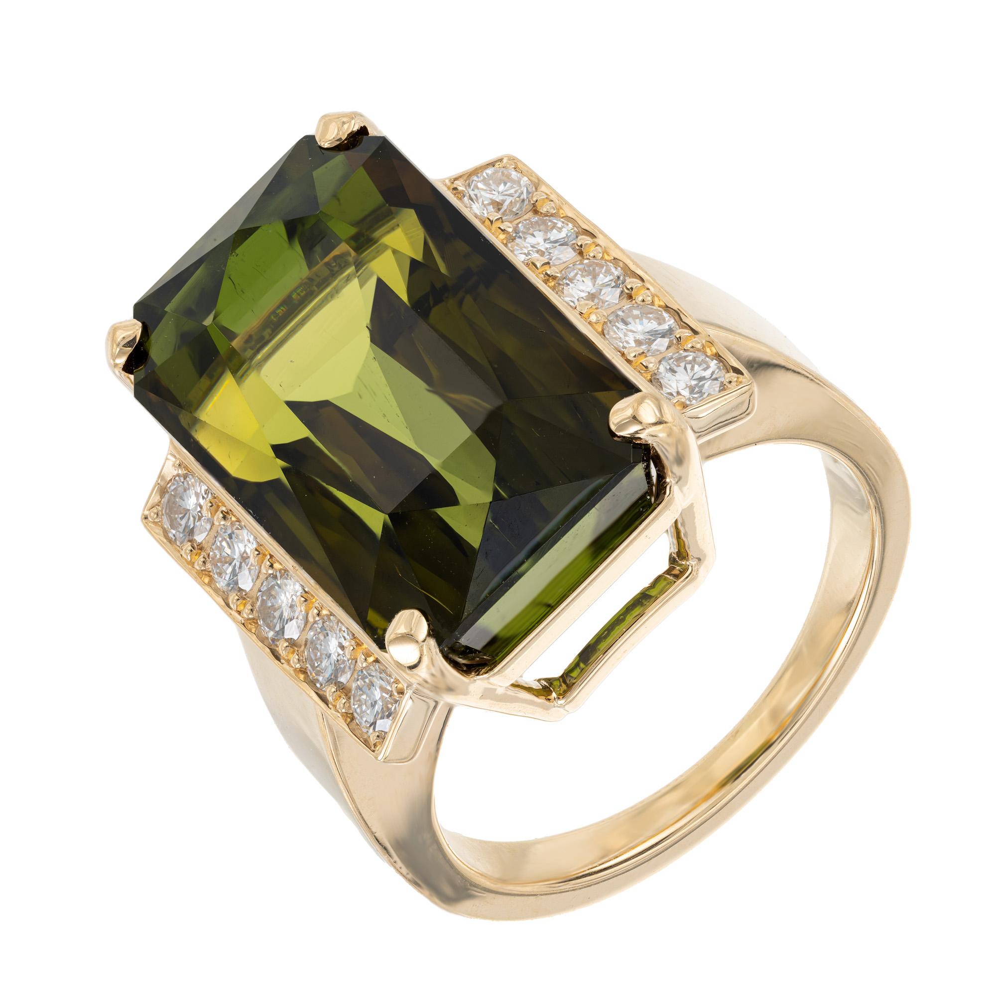 Stunning rare green tourmaline and diamond cocktail ring. This spectacular 17.44ct. octagonal tourmaline has a 3D green coloring accented with a yellowish and almost slight peach coloring across the middle. Truly unique. It is mounted in a 18k
