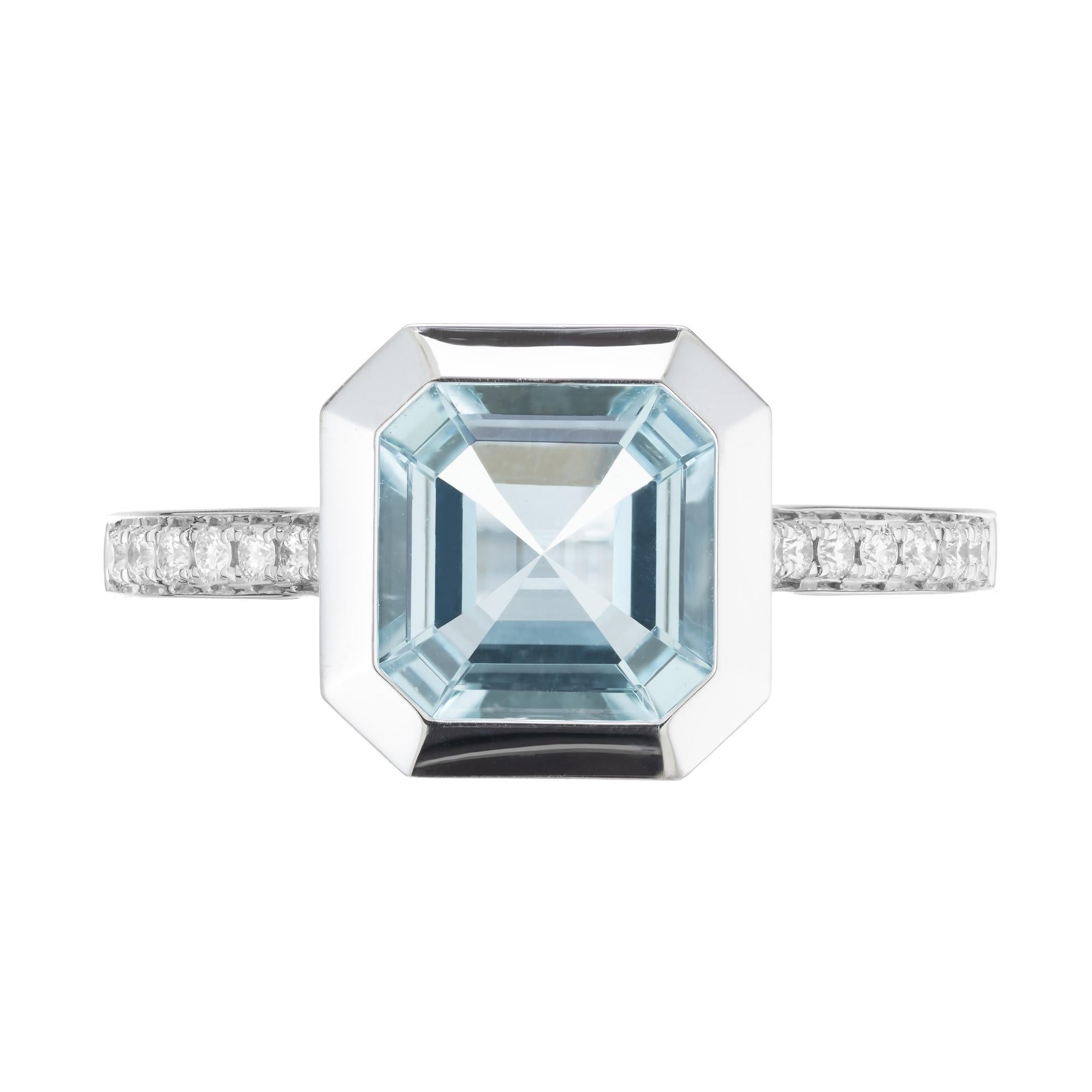Bright, clear blue aquamarine and diamond ring. 1.80ct eight sided bezel set aquamarine in a 14k white gold setting designed to show off the natural beauty of the stone. The stone is accented with 14 round brilliant cut diamonds along the shoulders.