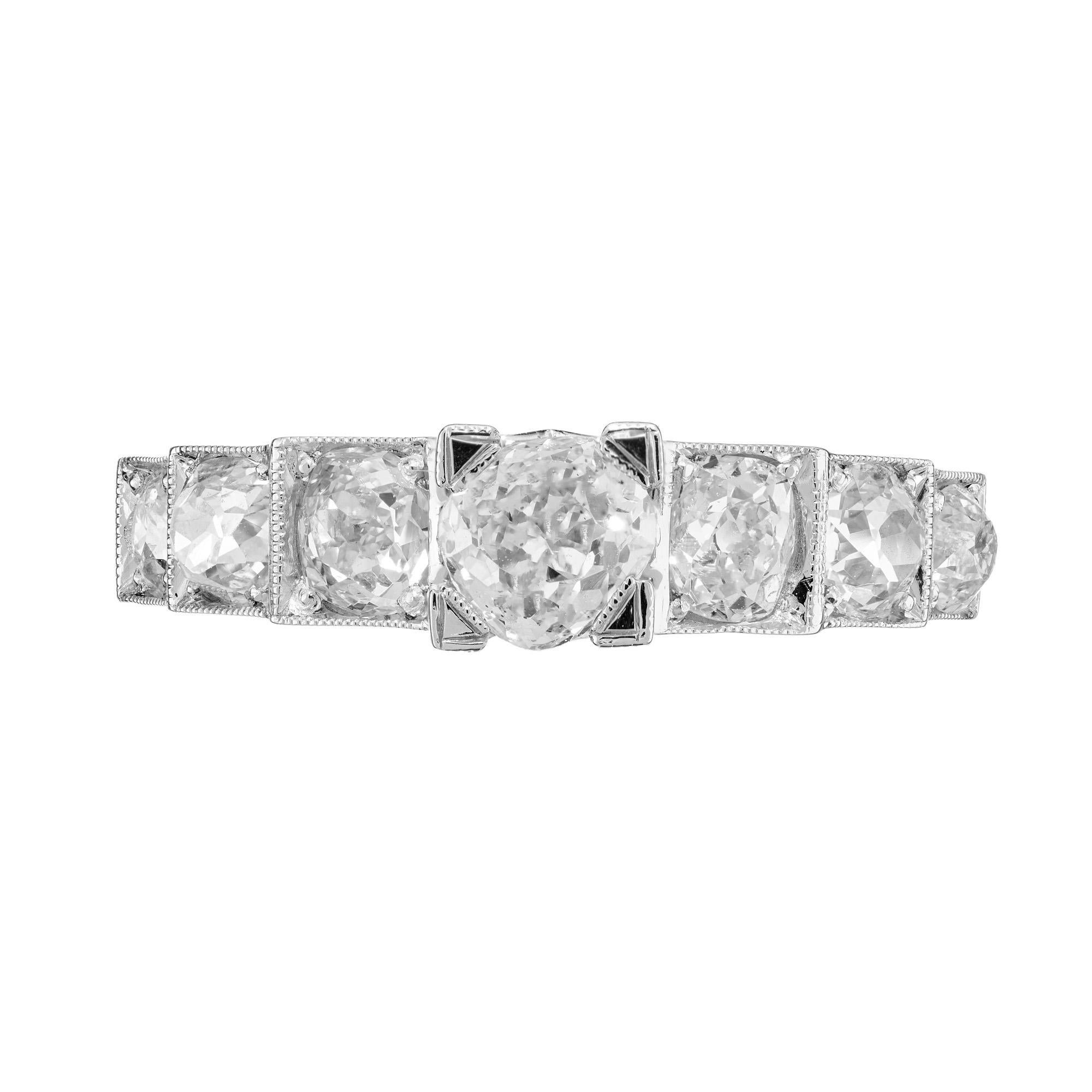 Crafted in the Peter Suchy Workshop, this 1890's antique revival engagement ring setting show cases 7 dazzling old mind cut diamonds with an approximate total carat weight of 1.82cts. This vintage inspired platinum design begins with a .55ct center
