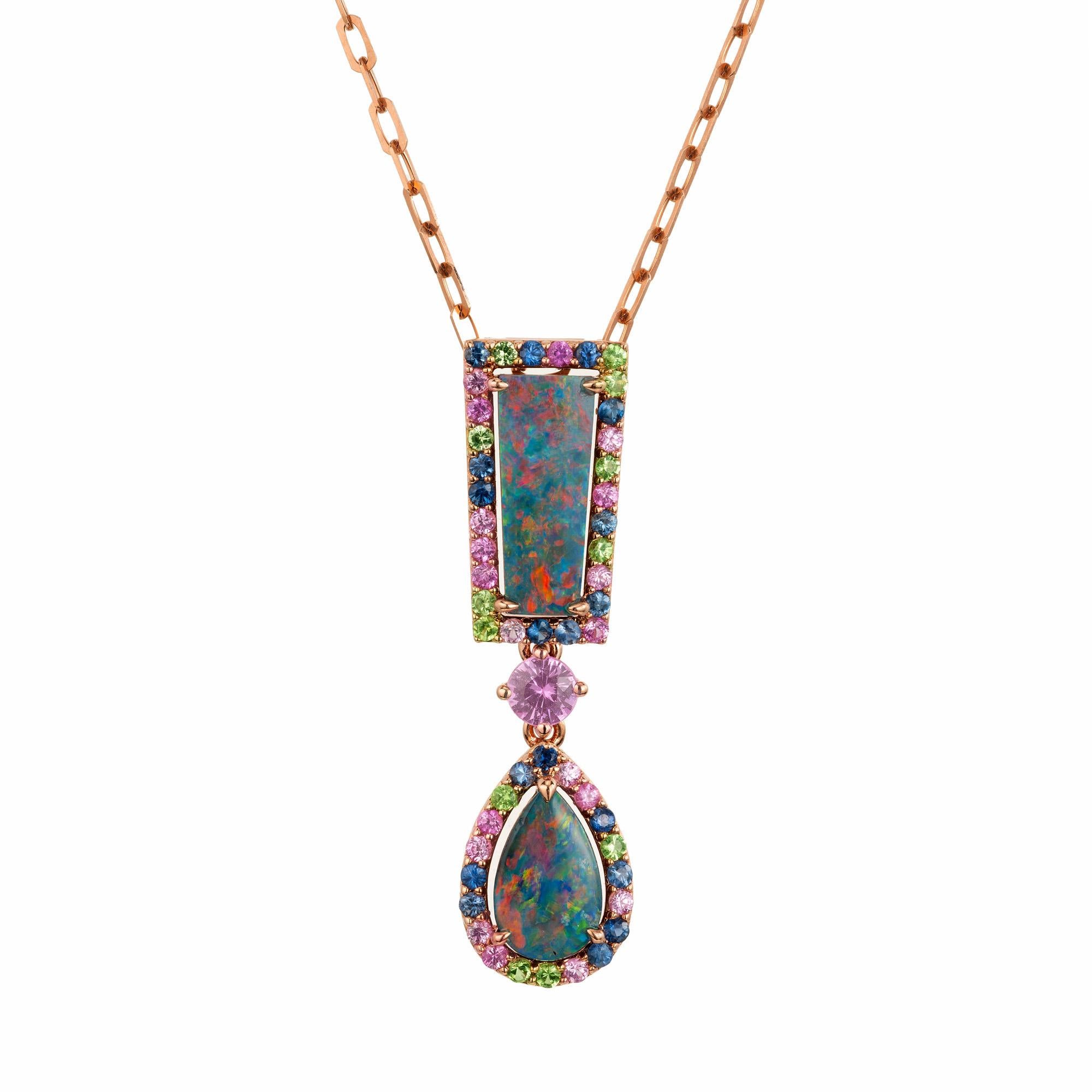 Discover the enchanting allure of the Peter Suchy 1.83ct Opal and sapphire Sapphire rose gold pendant necklace. One rectangle and one pear shaped opals mounted in 18k rose gold. Both opals have a halo of pink, blue and green round sapphires and are