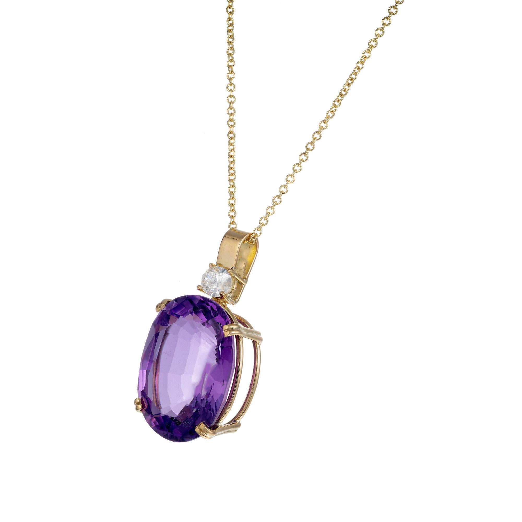Purple amethyst and diamond pendant necklace. 18.42ct oval amethyst with a round accent diamond on bail, set in 18k yellow gold with a 18 inch chain. Crafted in the Peter Suchy Workshop.  

1 oval purple amethyst approx. 18.42cts
1 round diamond G,