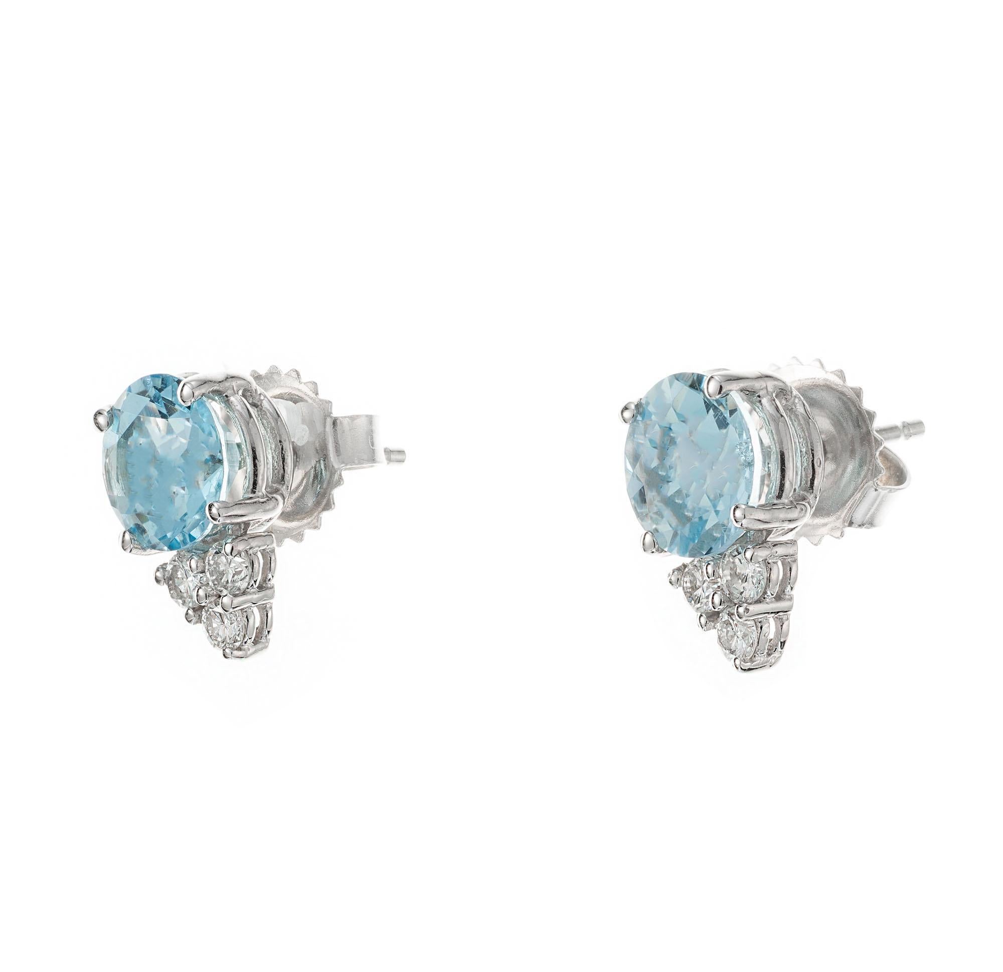 Aqua and diamond earrings. 2 round blue aquamarines set in 14k white gold basket settings with 6 round brilliant cut diamonds. Designed and crafted in the Peter Suchy workshop.

2 round blue aquamarines, VS approx. 1.87cts
6 round brilliant cut