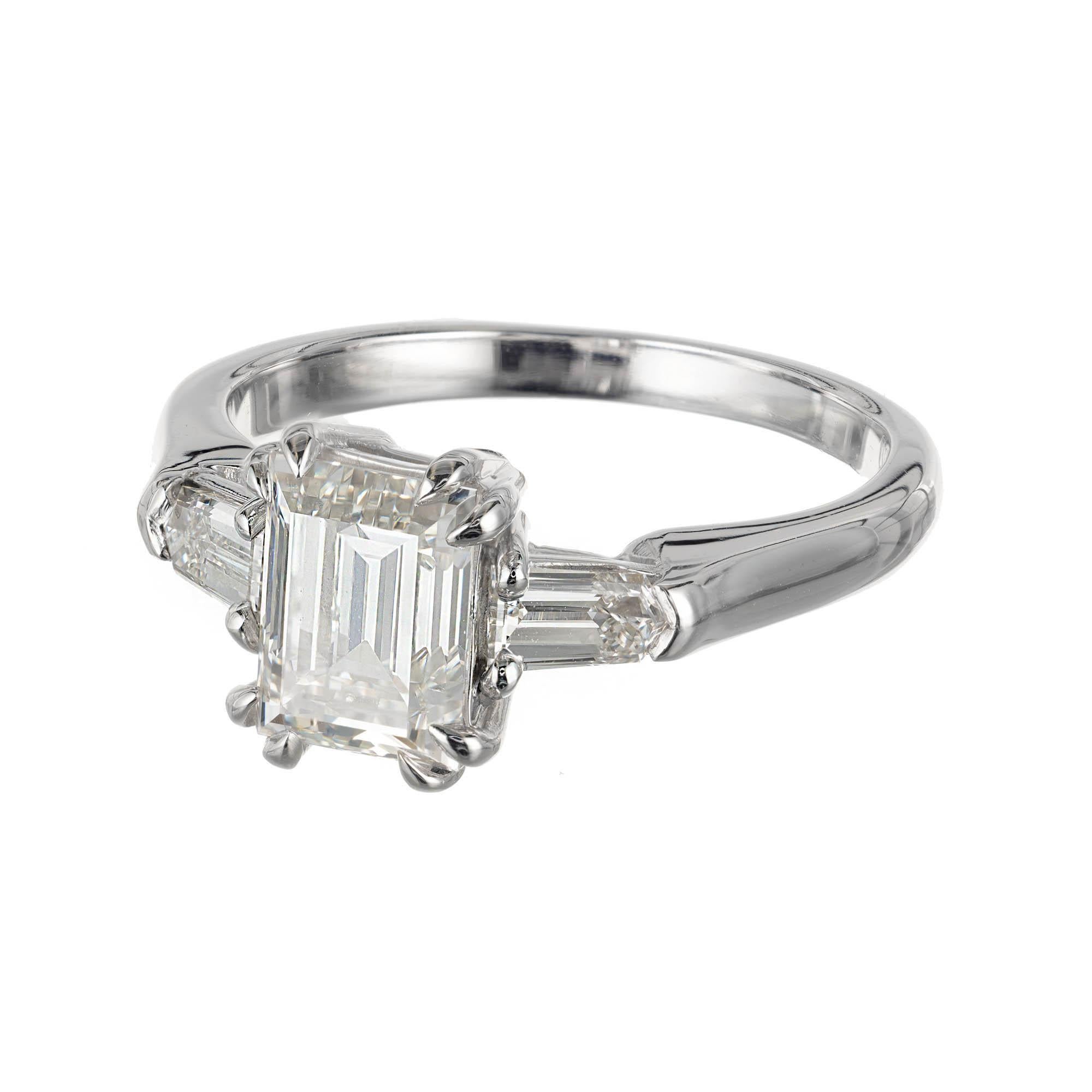 Emerald step cut sparkly diamond three-stone engagement ring. Emerald cut center stone with two step cut side diamonds in a platinum setting designed and crafted in the Peter Suchy Workshop. GIA Certified. 

1 emerald step cut I VS diamond,