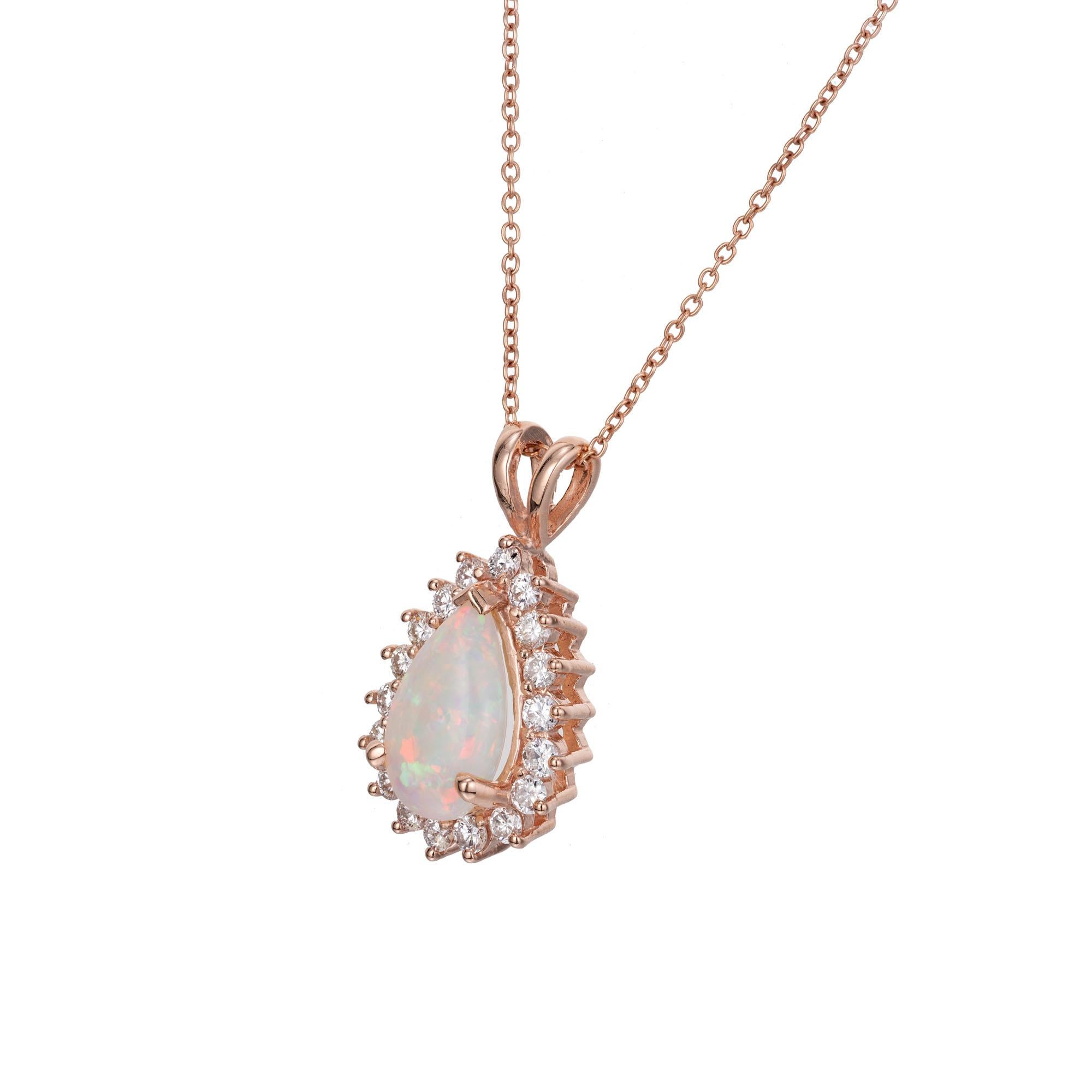 Green, red and blue opal and diamond pendant, necklace. 1 pear shaped cabochon opal with a halo of 18 round brilliant cut diamonds set in a 14k rose gold setting. 18 inch 14k rose gold chain. 

1 pear shaped cabochon opal, approx. total weight: