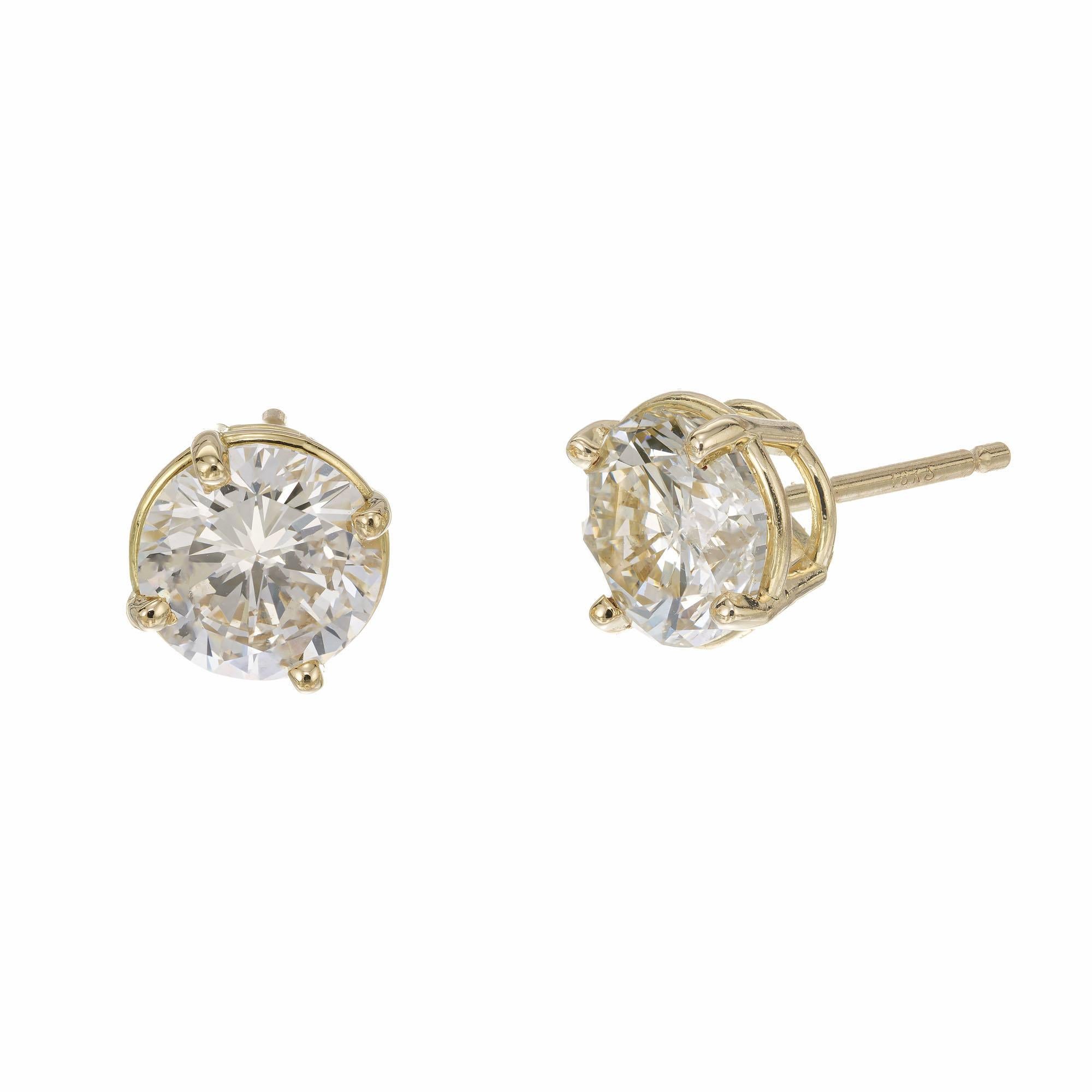Diamond stud earrings. 2 round brilliant cut diamonds in 18k yellow gold basket settings. The diamonds are from a 1940's estate. Designed and crafted in the Peter Suchy Workshop.

1 round brilliant cut diamond, K-L SI3 approx. 1.01cts EGL