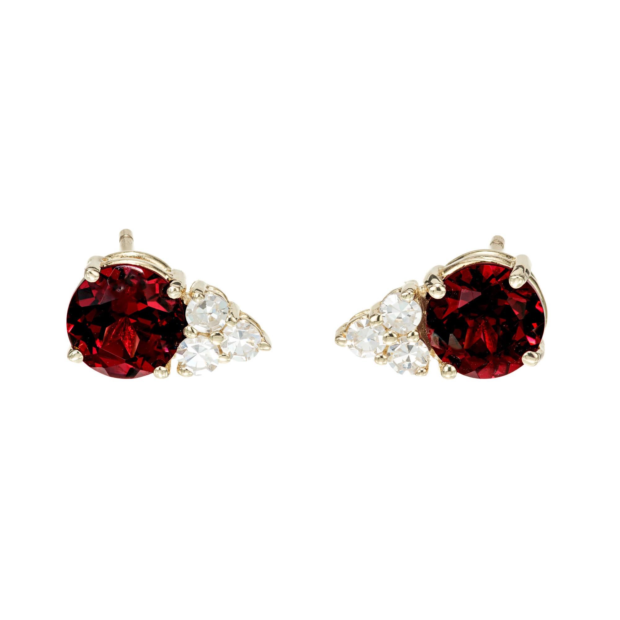 Rhodolite garnet earrings with brightly colored diamond accents. 2 round brownish red rhodolite garnets set in 14k yellow gold settings, each with 3 round brilliant cut diamonds.  Designed and crafted in the Peter Suchy workshop.

2 round brownish