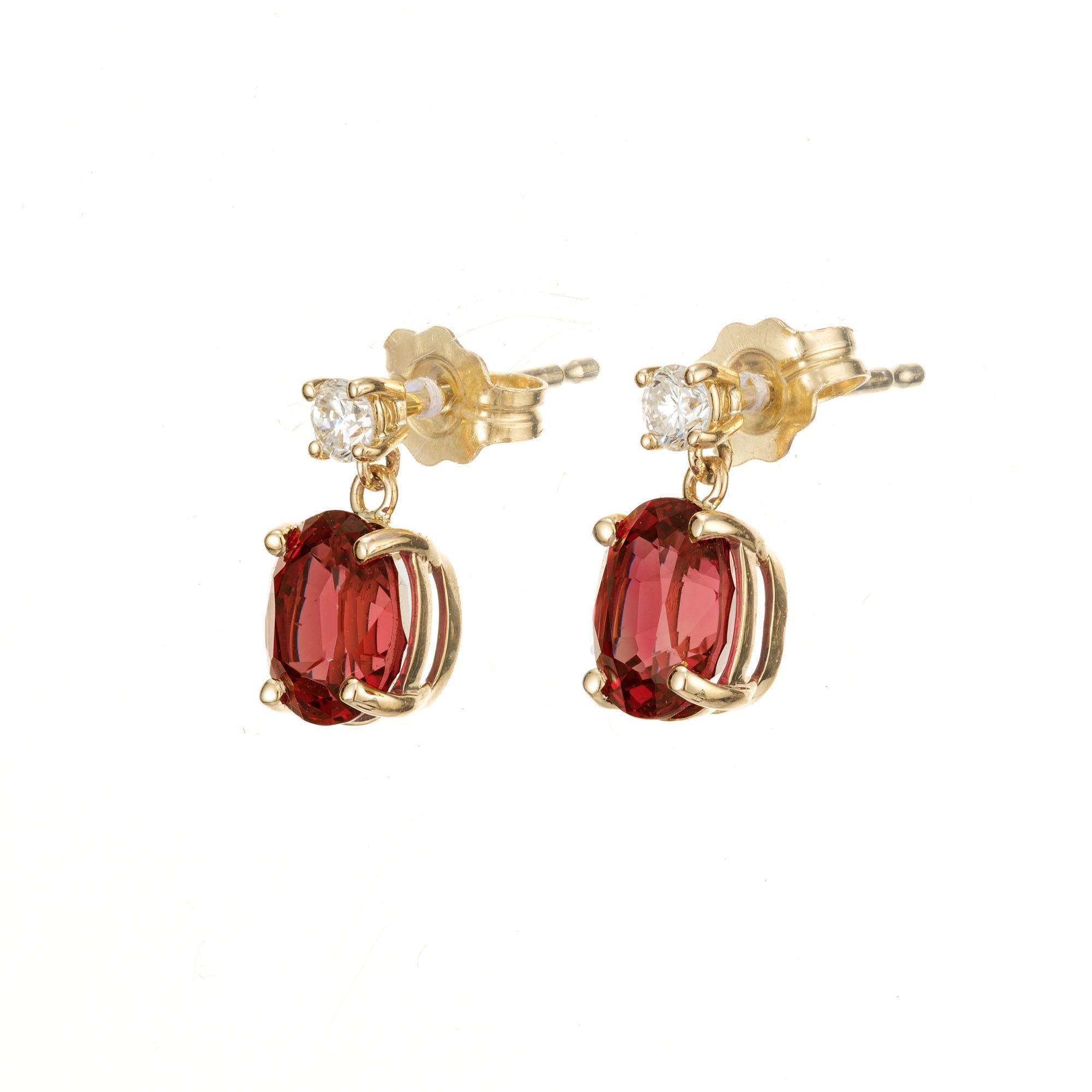 Oval spinel and round diamond earrings. 2 round brilliant cut diamonds with 2 oval red natural, untreated spinel dangles. The spinels are circa 1950's. Designed and crafted in the Peter Suchy workshop

2 oval red spinel's, VS approx. 2.04cts
2 round