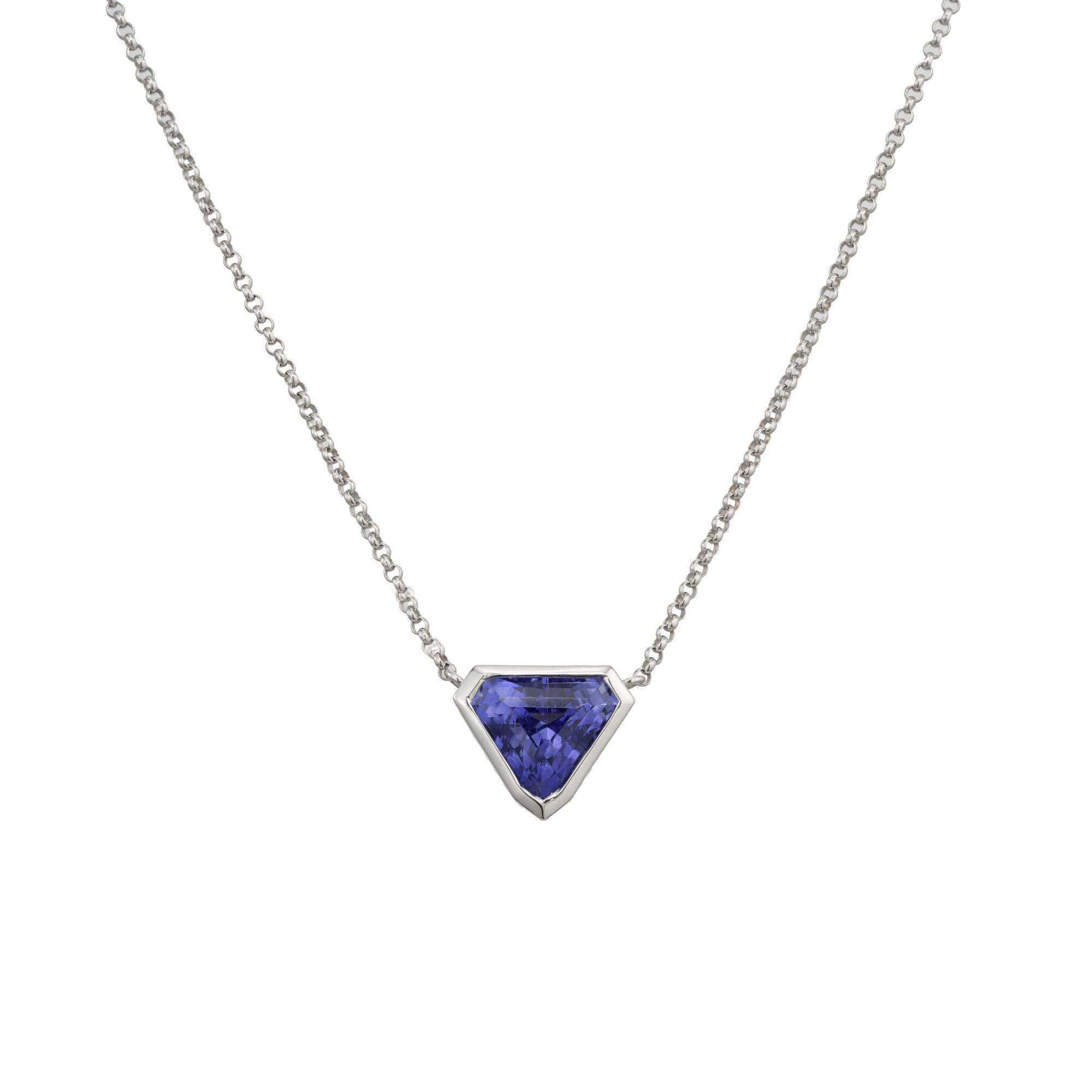 Outstanding bright blue sapphire pendant necklace. Triangular cut bezel set 2.05ct gemstone. Framed in 18k white gold, the stone is from the late 1800's and transformed into a simple handmade pendant by the Peter Suchy Workshop. 16.25 inch chain.