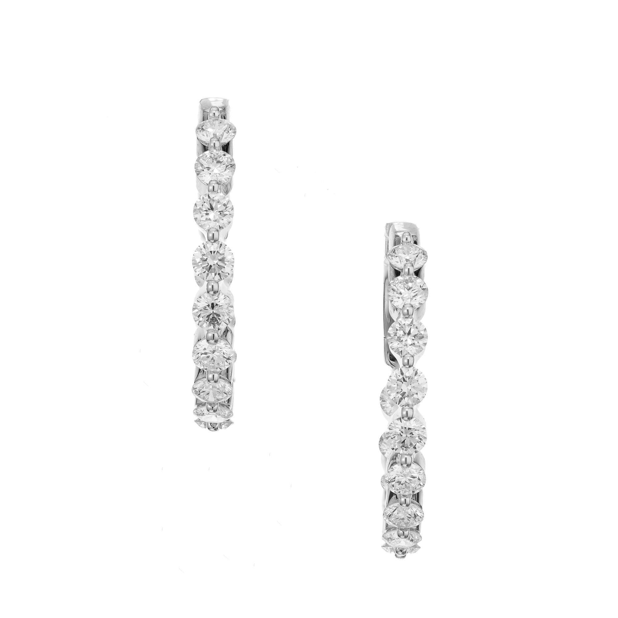 Fantastic one inch white gold inside out diamond hoop earrings. 26 round brilliant cut diamonds, with a total carat weight of 2.06cts. Set in an inside out design with safe custom clip back and post. Each diamond is expertly set to enhance its