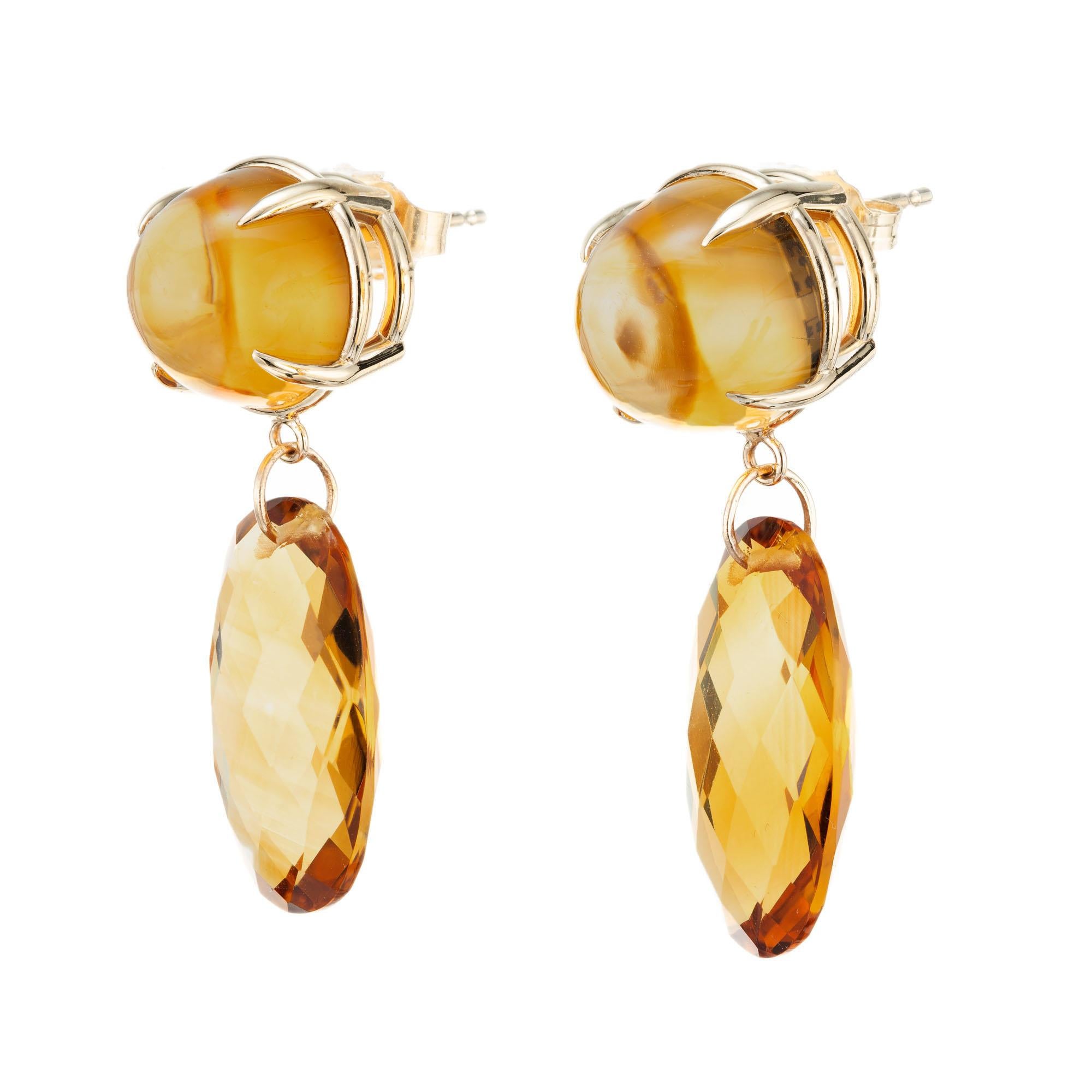 Citrine dangle earrings. Natural untreated round high dome faceted cabochon tops with two oval briolette citrine dangles. Designed and crafted in the Peter Suchy Workshop

2 round yellowish orange cabochon citrines, approx. 10.33cts
2 oval faceted