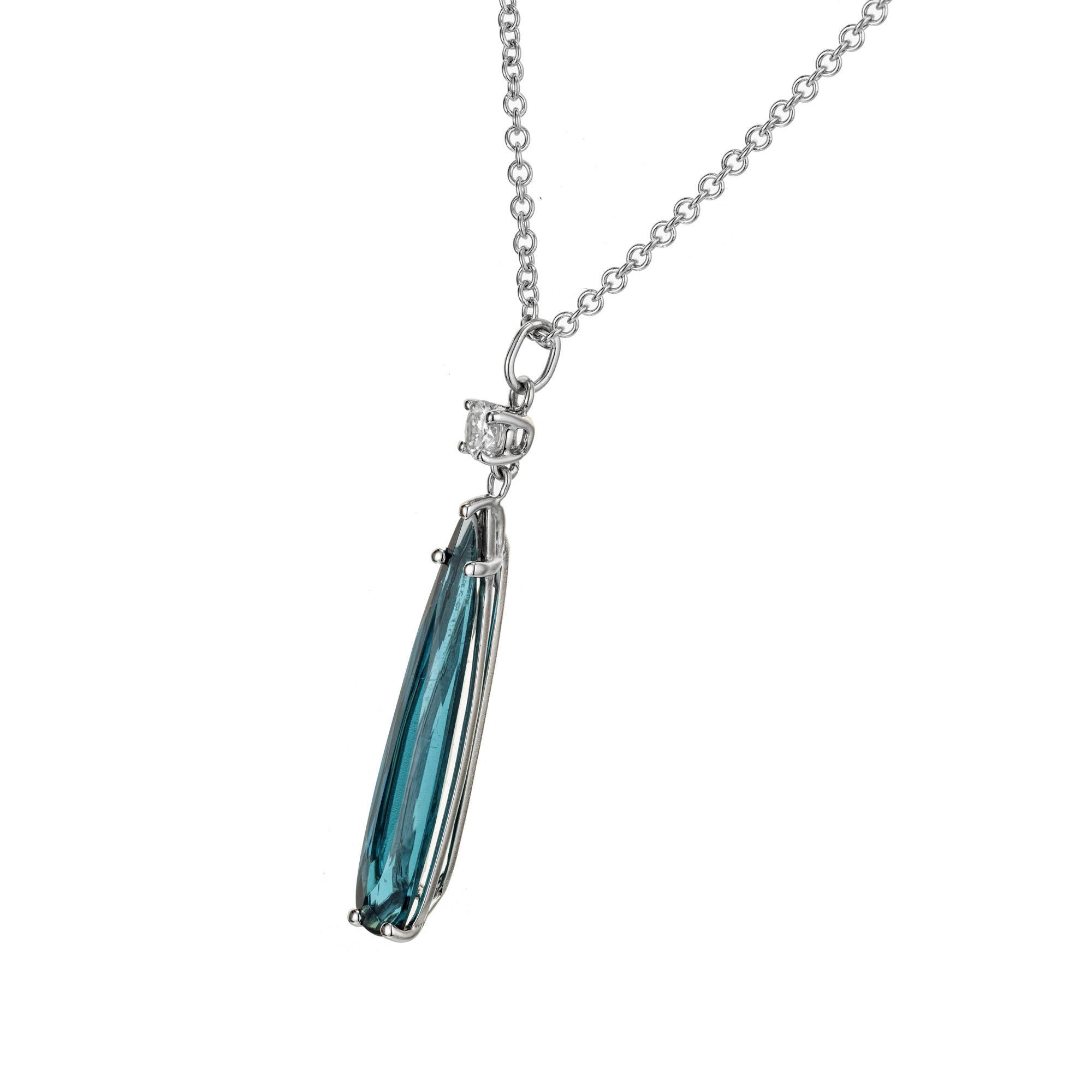 Blue green elongated tourmaline diamond pendant. Pear shaped tourmaline set in 14k white gold, accented with 1 round brilliant cut diamond, 16 inch necklace. Designed and crafted in the Peter Suchy workshop.

1 pear shaped blue tourmaline, VS
