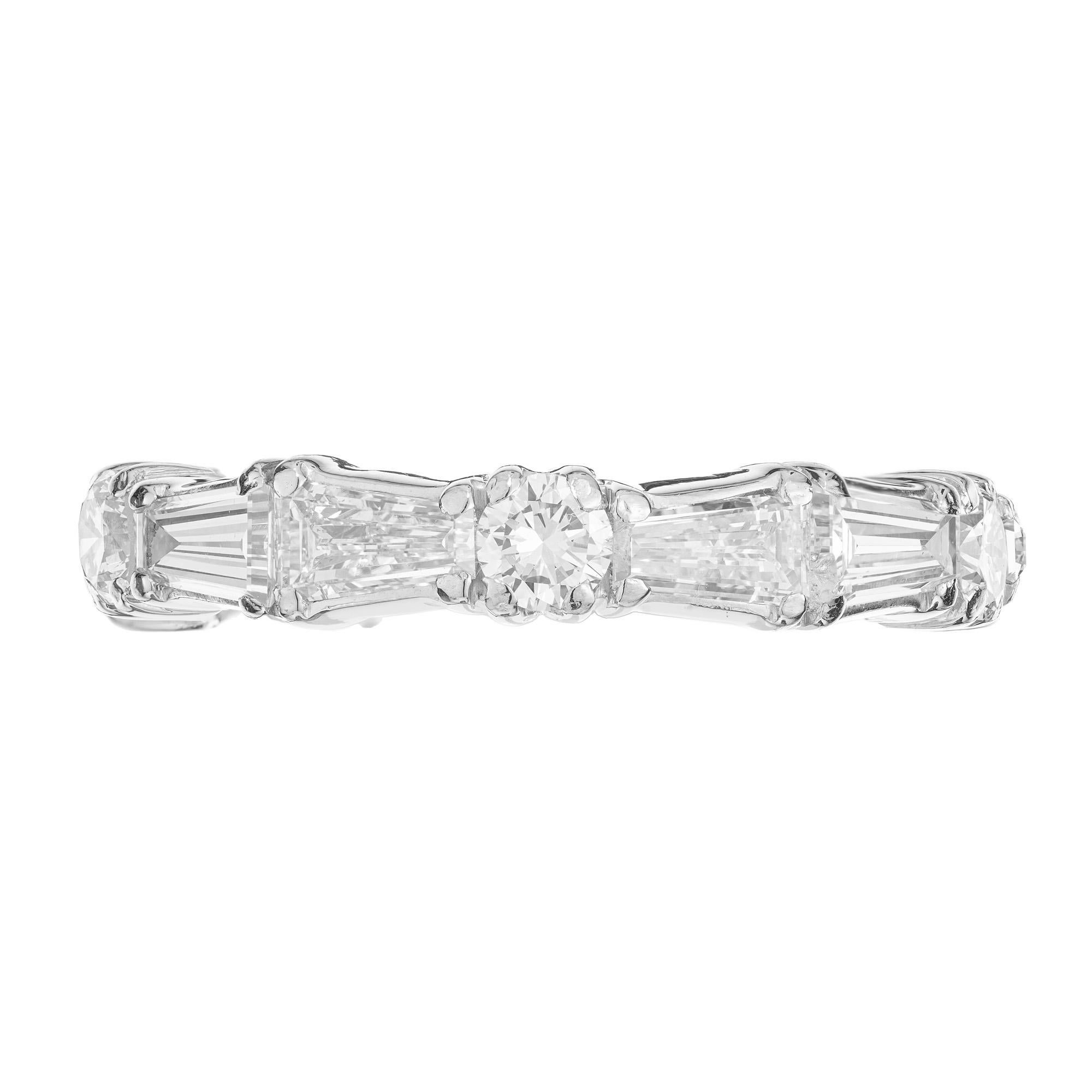 Custom made and custom design diamond platinum wedding band ring. This ring is set with ten tapered baguettes diamonds in a pair pattern that are separated by 5 round brilliant cut diamonds. While this ring is not easily sizable, it can be ordered