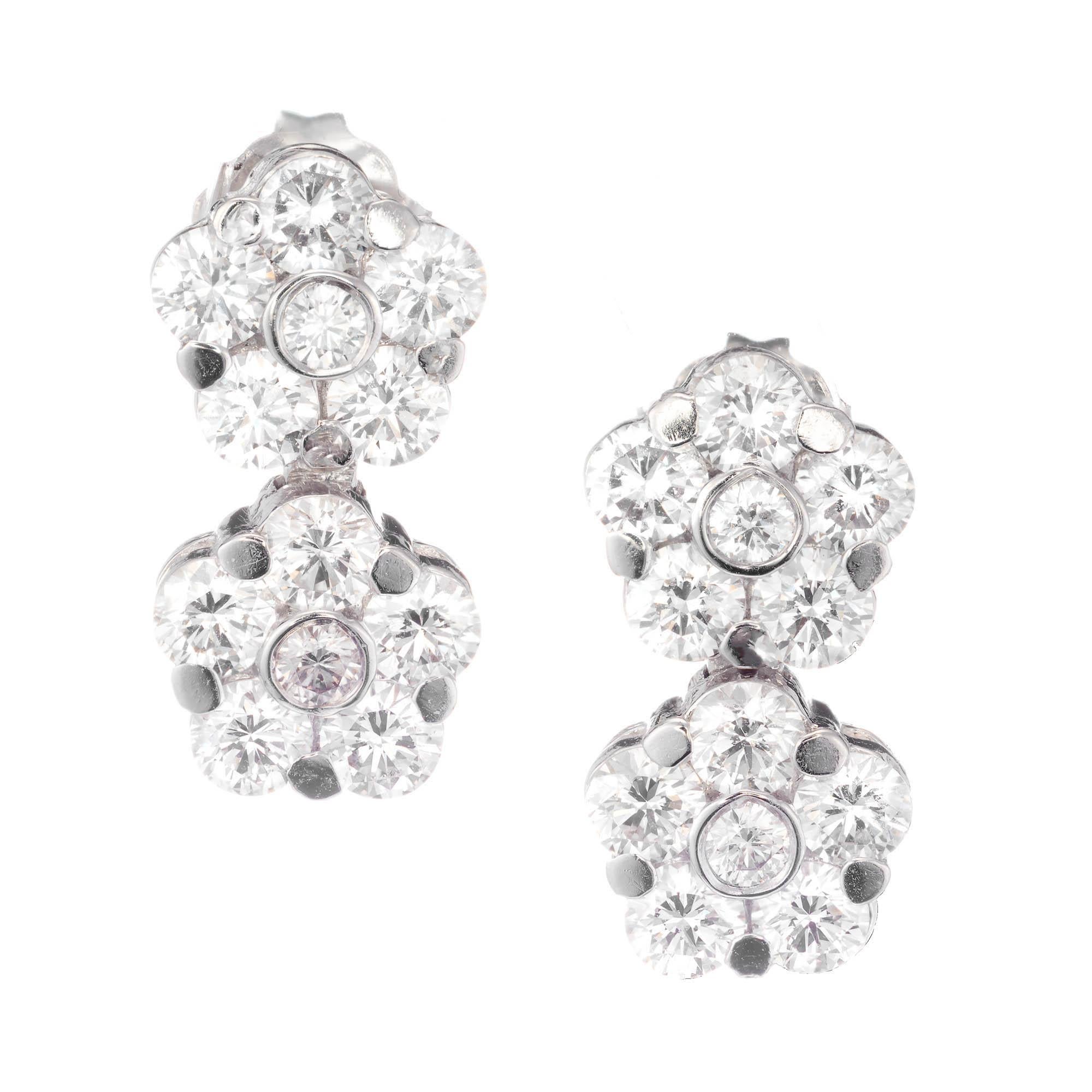 Peter Suchy diamond flower double drop dangle earrings in 18k white gold.

24 round brilliant cut FG VS diamonds, Approximate 2.11 carats 
18k white gold 
Stamped: 18k
3.4 Grams
Top to Bottom: 14.2mm or .56 Inches
Width: 7.4mm or .30 Inches
Depth or