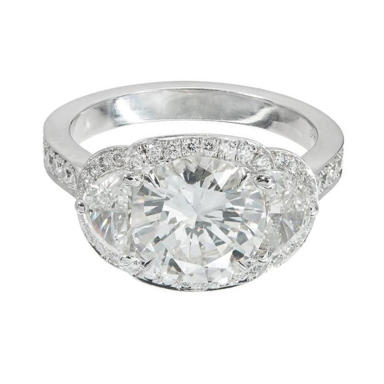 Transitional cut round diamond three-stone engagement ring. 2.30ct center stone with 2 have moon side diamonds and a halo of round diamonds in a platinum setting made by the Peter Suchy Workshop. EGL Certificate # US 44311402D

1 round transitional
