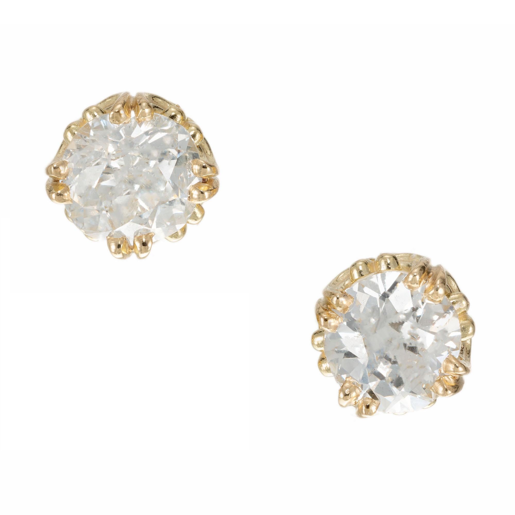 Open scroll design basket diamond stud earrings.  1 Old European cut 1.11ct diamond and one round brilliant cut 1.30ct diamond set in 18k yellow gold. Both stones are from a 1920's estate and certified by the EGL. Settings created in the Peter Suchy