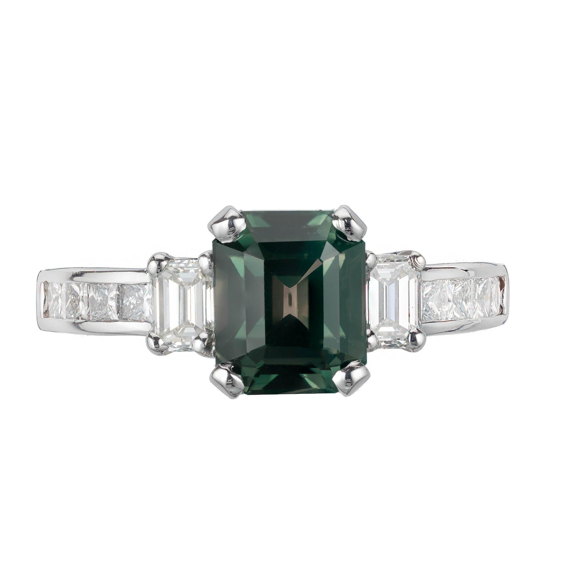 Peter Suchy sapphire and diamond three-stone engagement ring. The GIA Certified octagonal center stone is from an 1920's estate, accented with two emerald and eight princess cut diamonds, in a platinum setting designed by the Peter Suchy