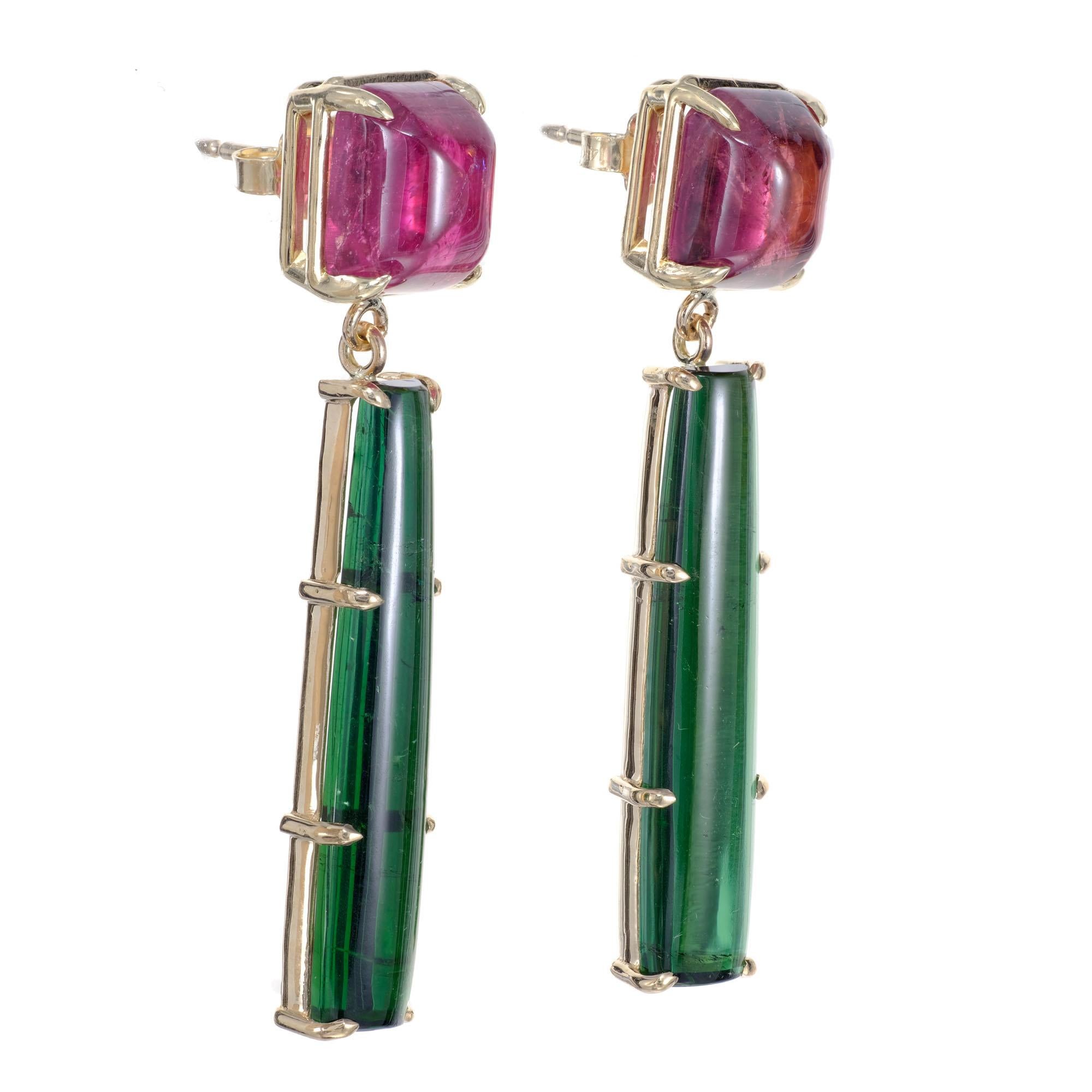 Handmade cabochon reddish pink and bright green tourmaline dangle earrings in 14k yellow gold. Created in the Peter Suchy Workshop.

2 rectangular cabochon pinkish red tourmalines, MI approx. 9.67cts
2 elongated rectangular green tourmalines, MI
