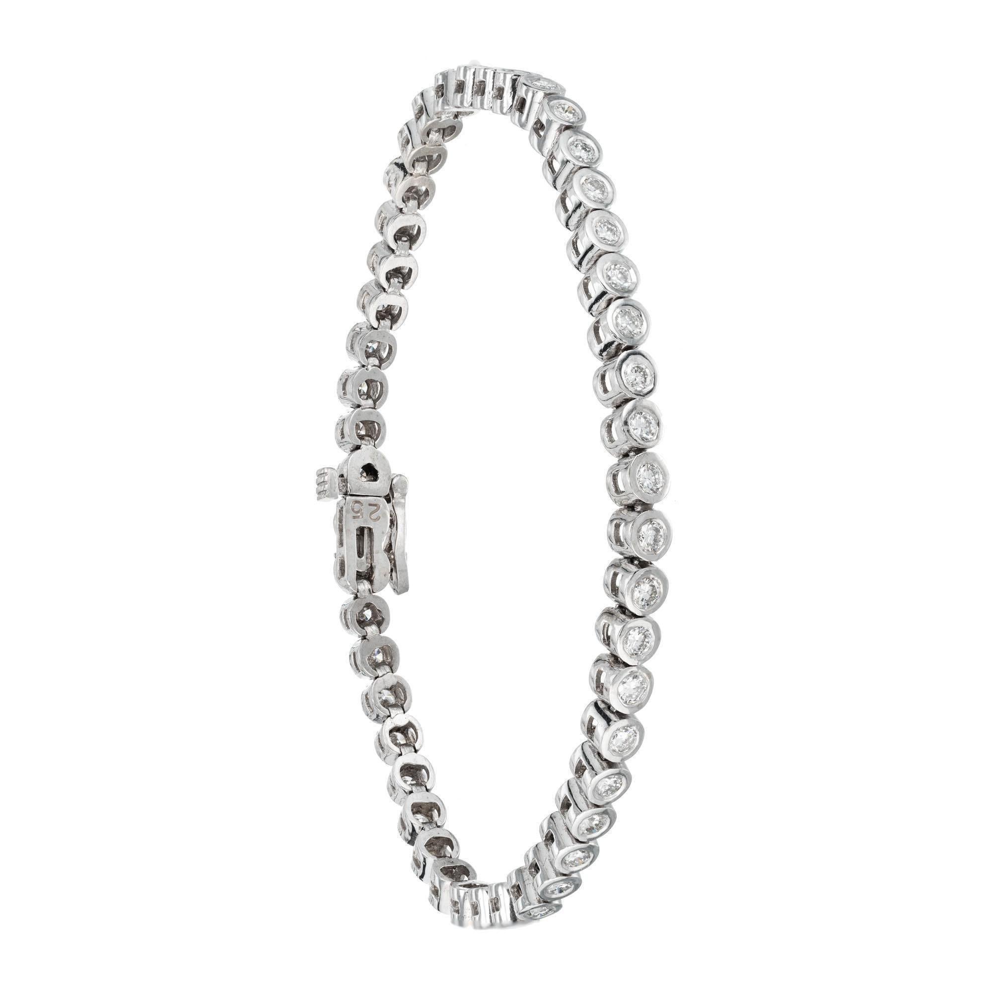 Round diamond bezel set tennis bracelet. 2.50 carats of 47 round diamonds set in 14k white gold bezels. Length 7.50 inches. Created in the Peter Suchy Workshop. 

47 round diamonds, approx total weight: 2.50cts G-H, SI1
14k White gold
Length: